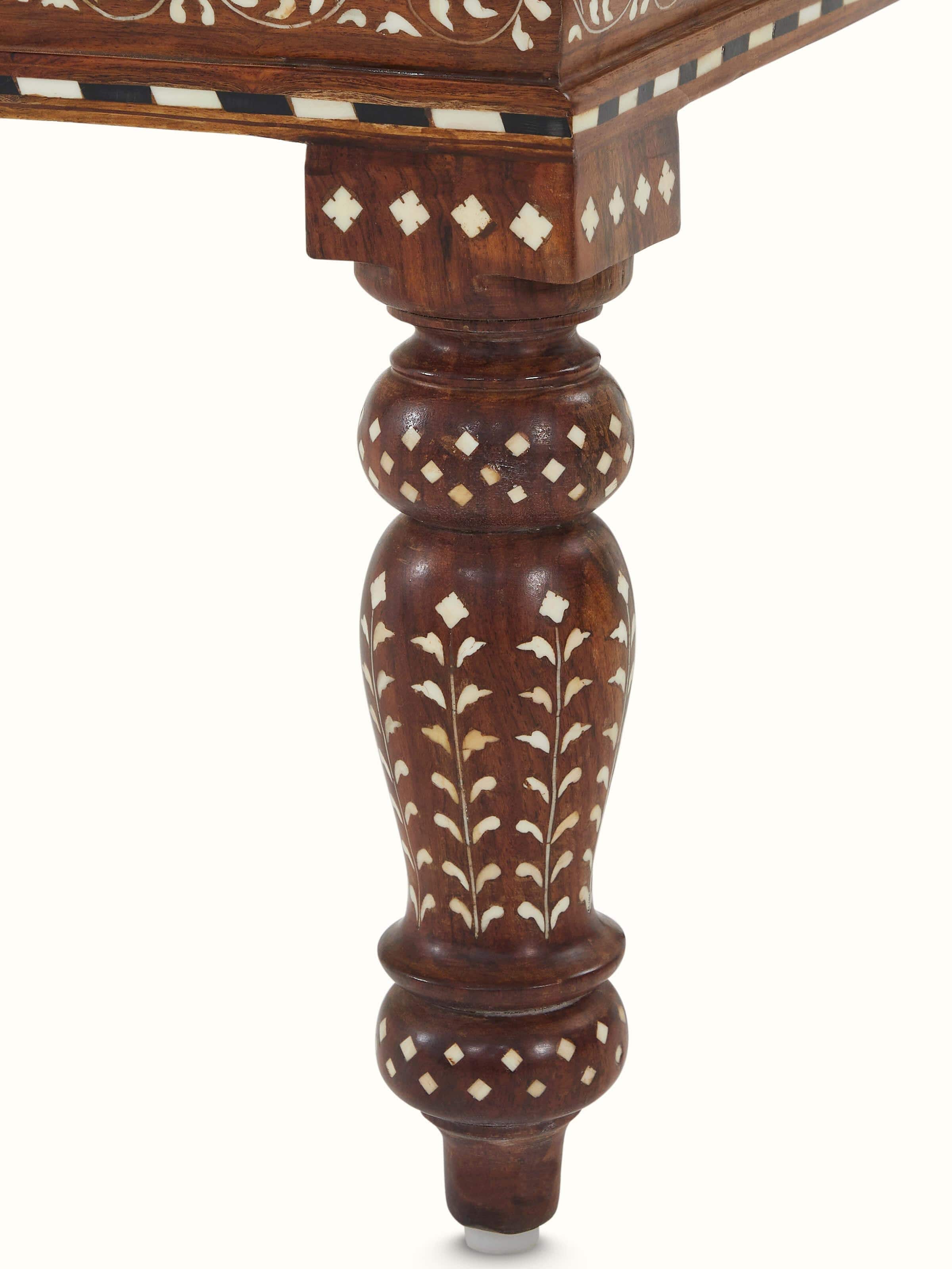 Artistic view of the upholstered Sheesham wood bench with bone inlay, highlighting the elegant design and craftsmanship