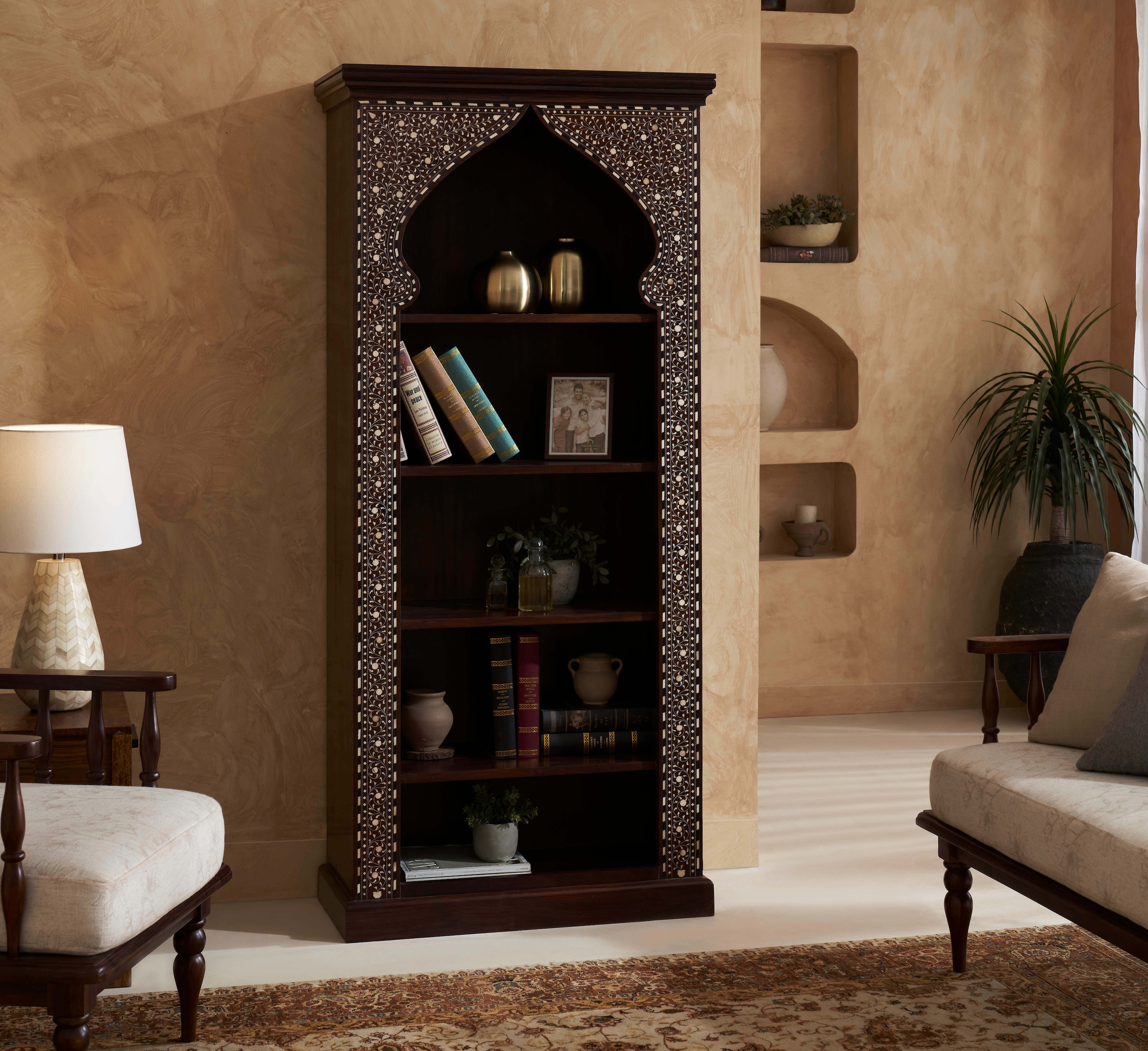 Close-up of the bone inlay details on the Sheesham wood bookshelf, showcasing the fine craftsmanship.