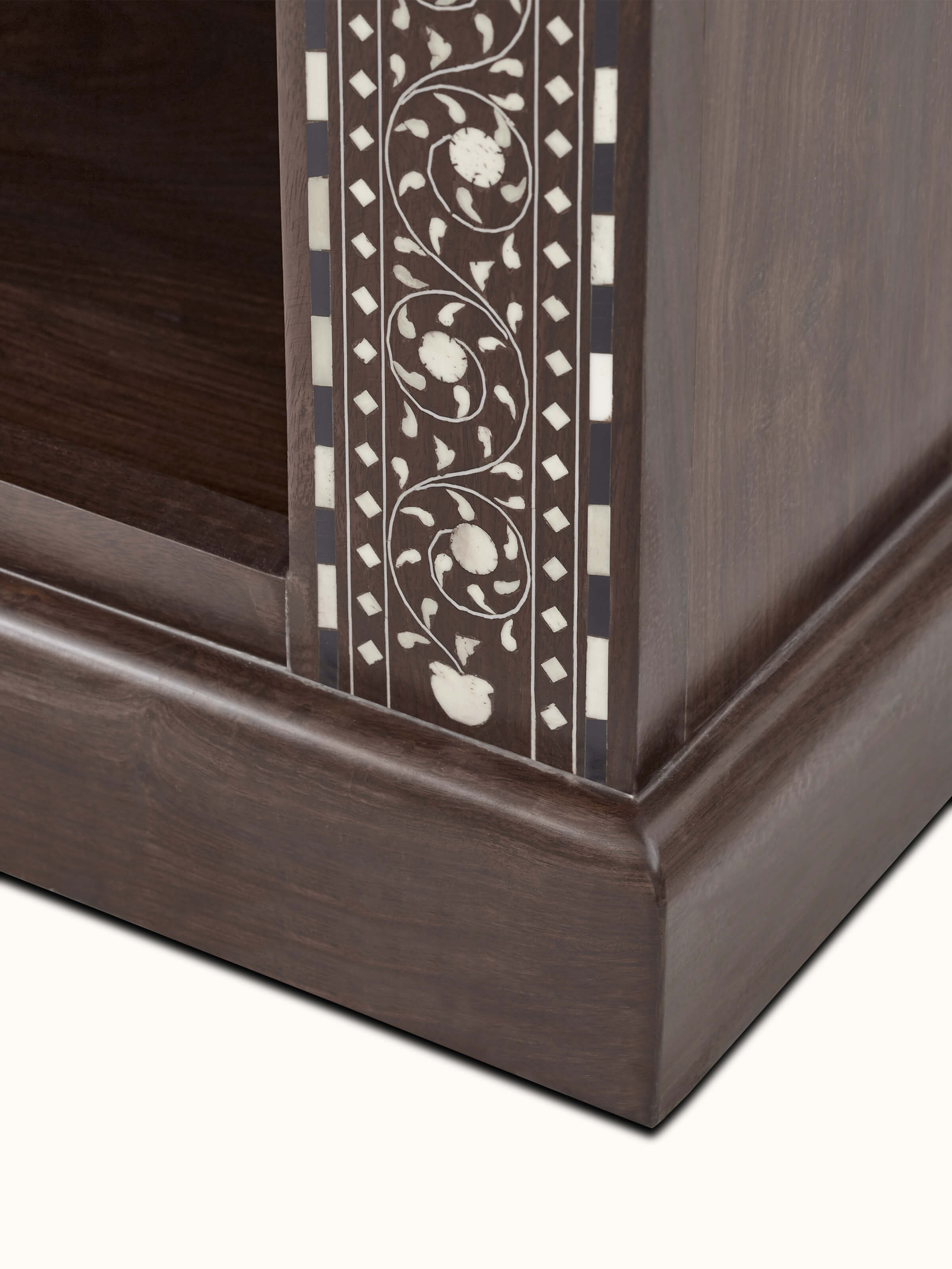 Angled view of the Sheesham wood bookshelf displaying the bone inlay design across multiple shelves.