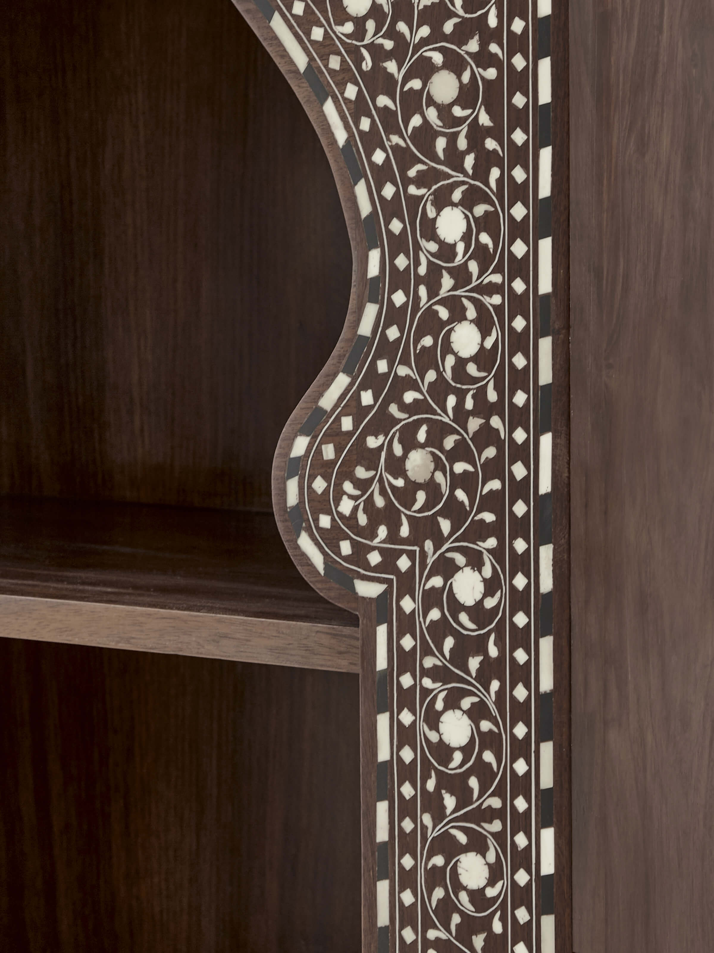 Detailed view of the bookshelf's back, highlighting the continuation of the bone inlay design.