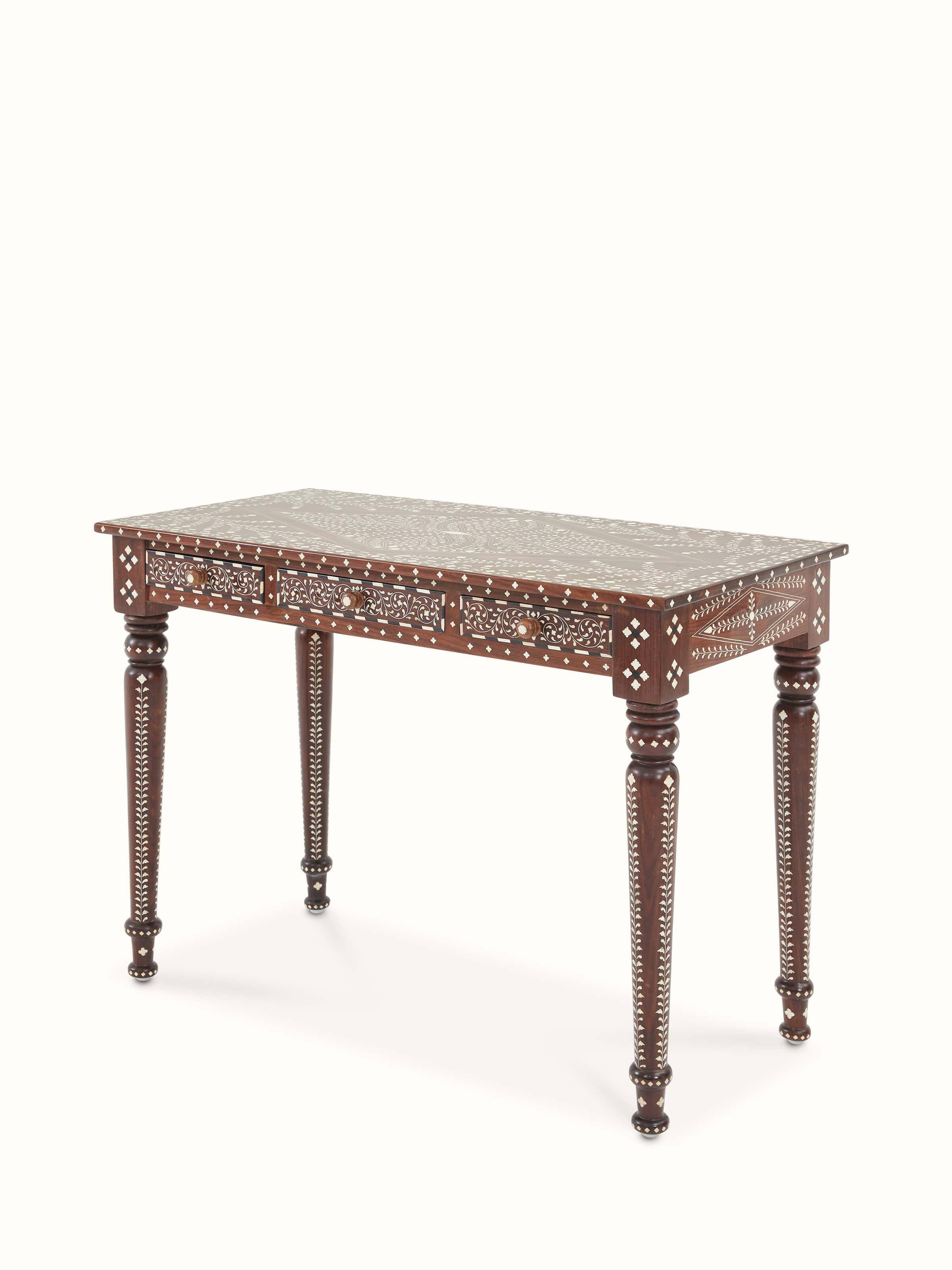 Angled view of bone inlaid sheesham wood study table, emphasizing the detailed inlay work and storage space.