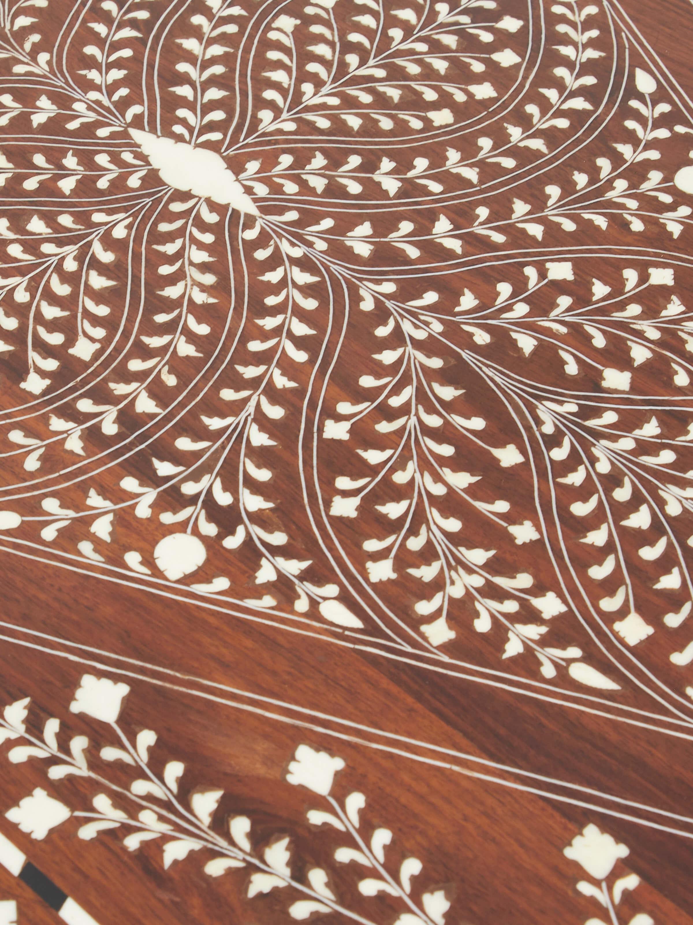 Close-up of bone inlaid sheesham wood study table, showcasing the intricate inlay patterns and fine details.