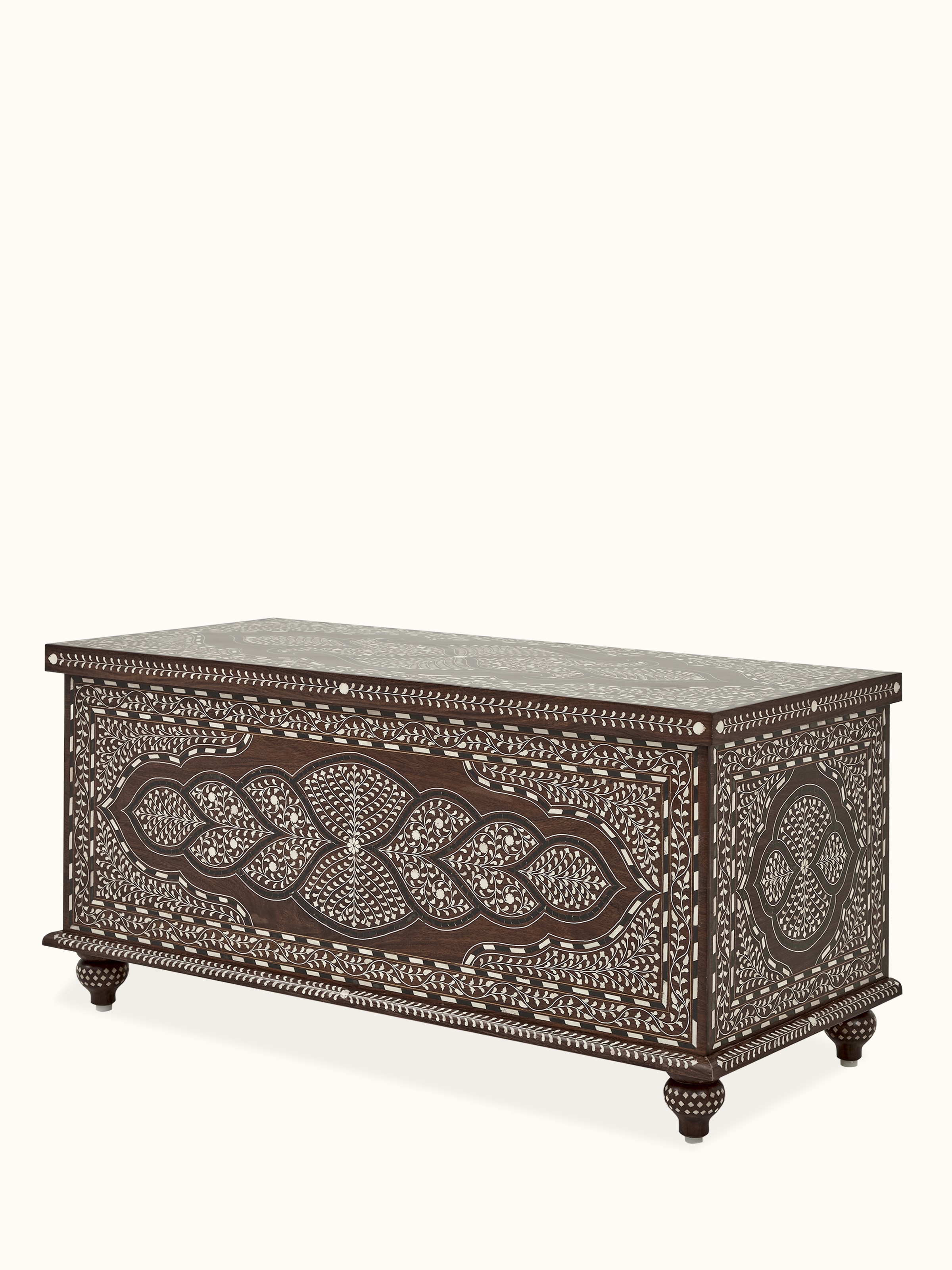 Angled view of the trunk, focusing on the combination of Sheesham wood and bone inlay, and the turned legs
