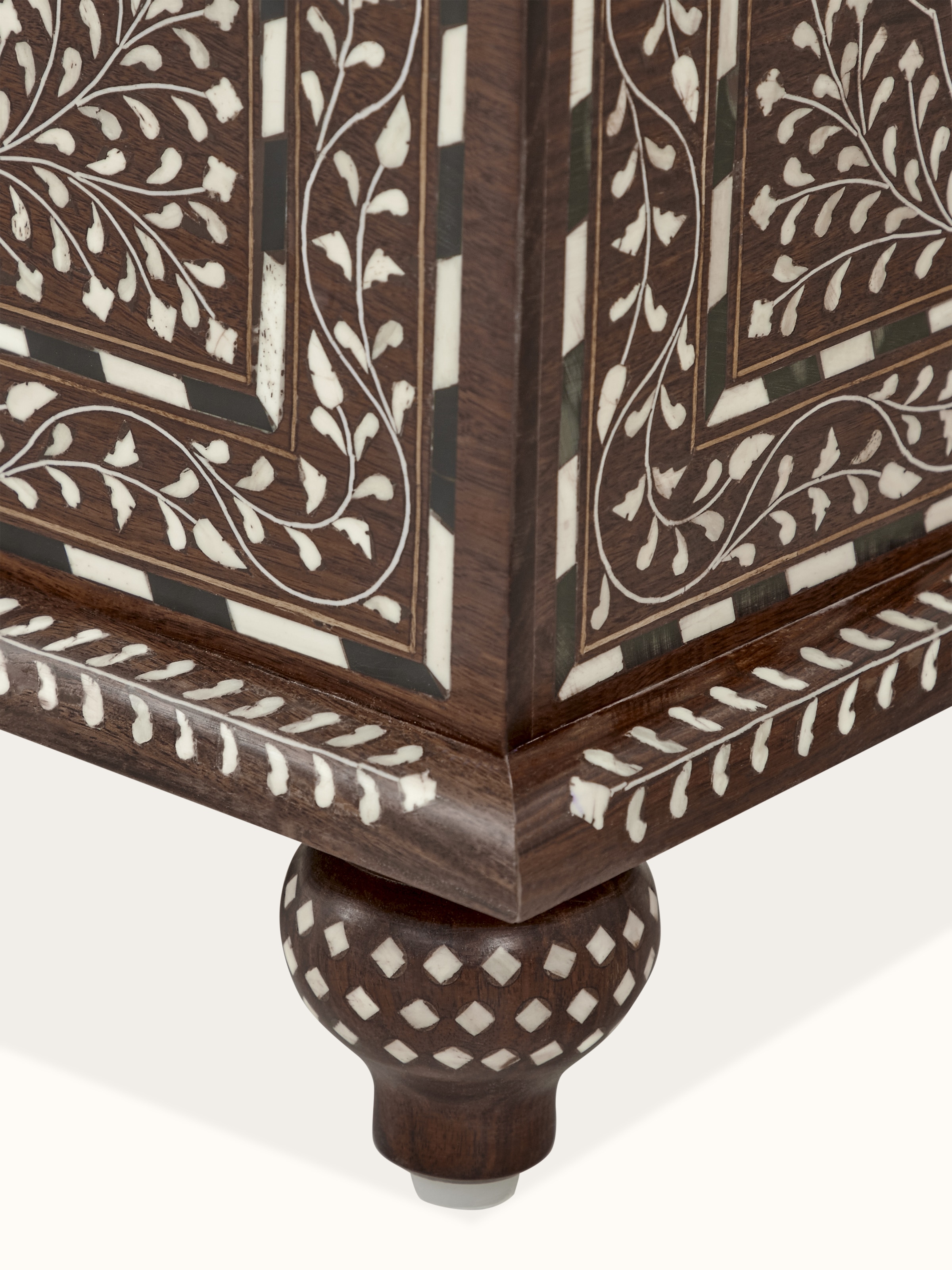 Detailed view of the trunk's bone inlay work, highlighting the craftsmanship and design elements