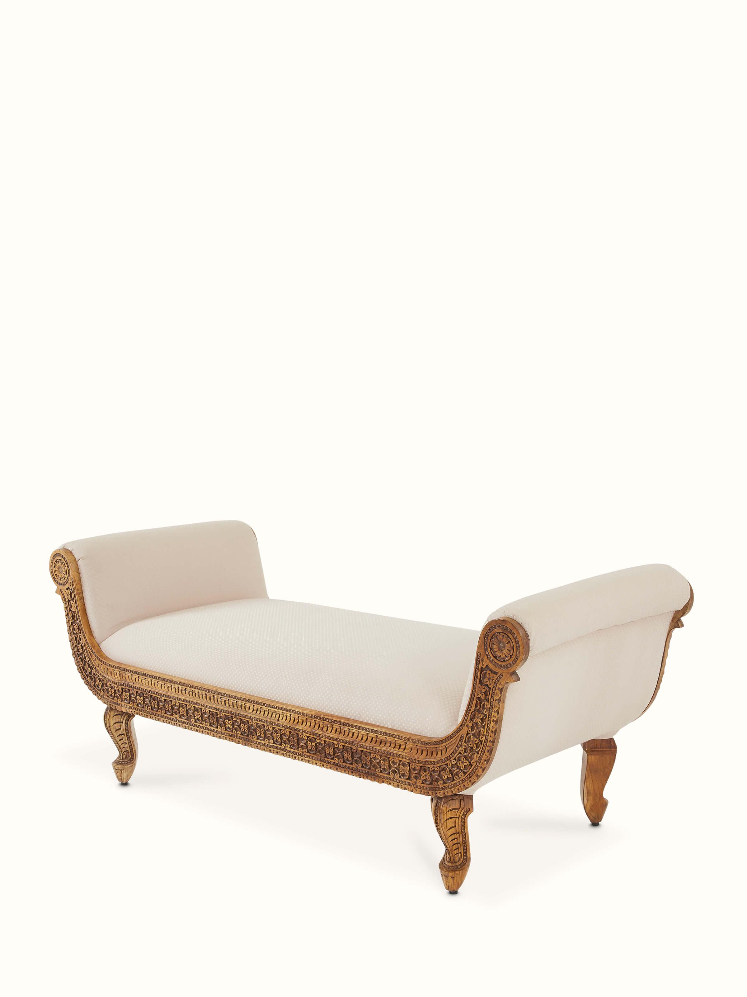 Close-up of the carved Sheesham wood upholstered bench, focusing on the detailed woodwork and fabric texture