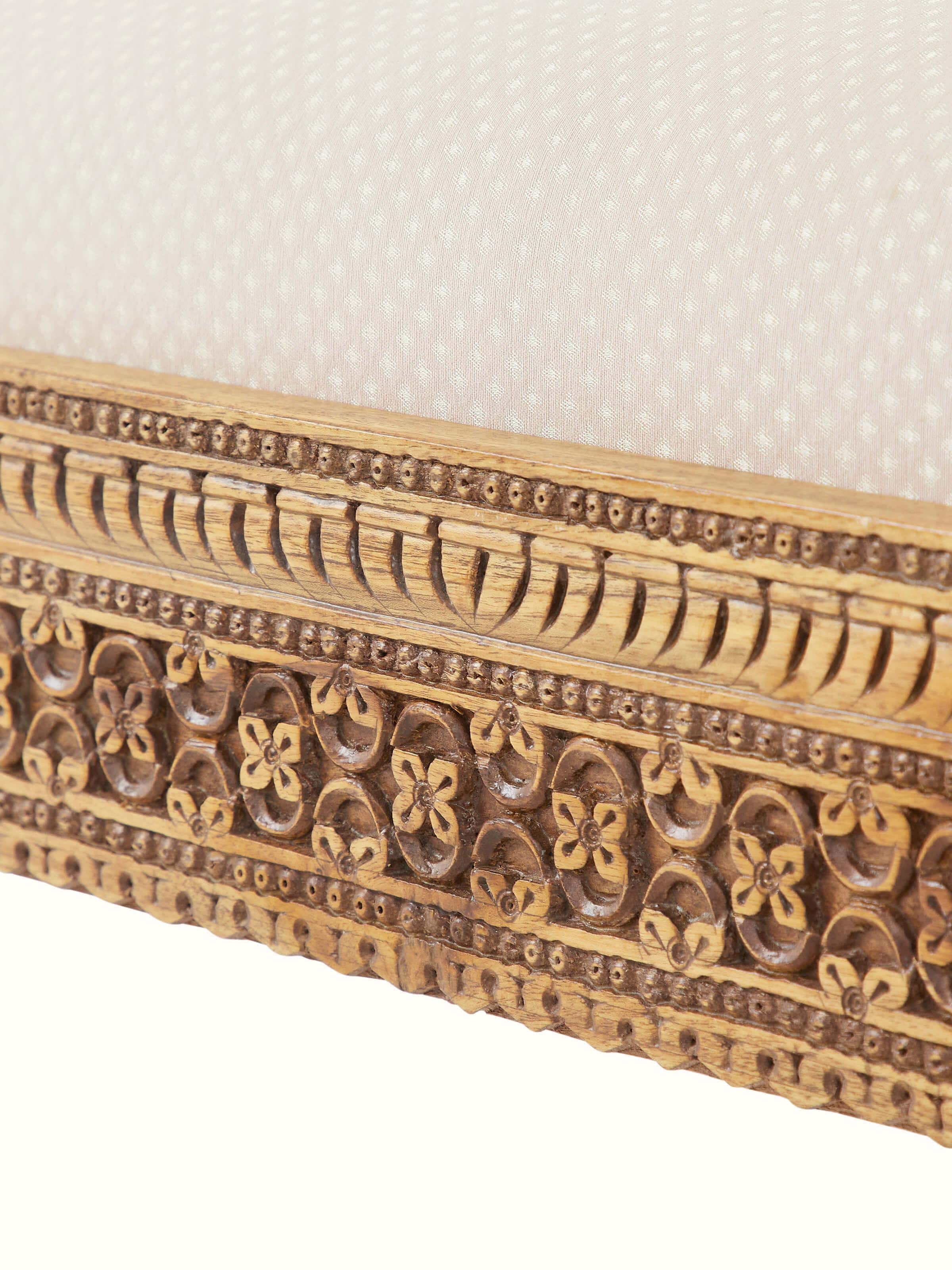 View of the carved Sheesham wood upholstered bench in a room setting, showing its fit and style in a practical setting