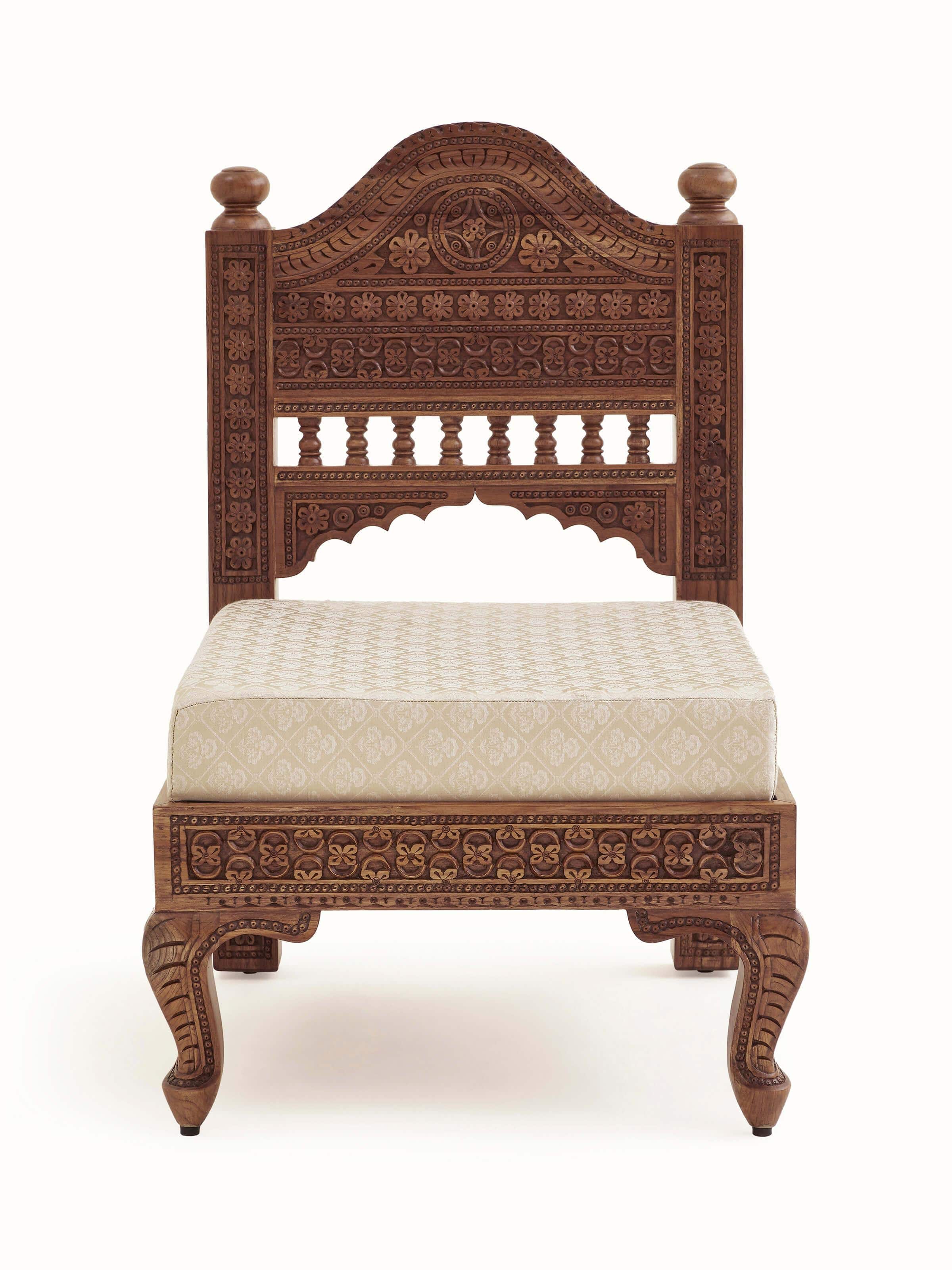 Front view of Carved Sheesham wood upholstered sofa showcasing intricate wood carvings and plush upholstery