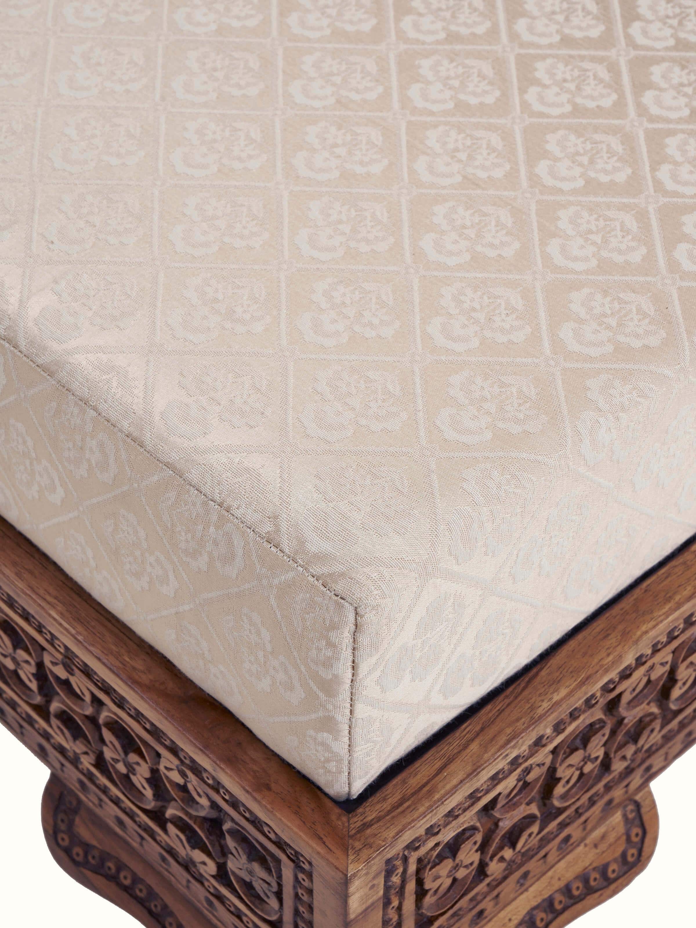 Detailed view of the carved Sheesham wood sofa’s armrests and upholstery, showcasing the intricate design