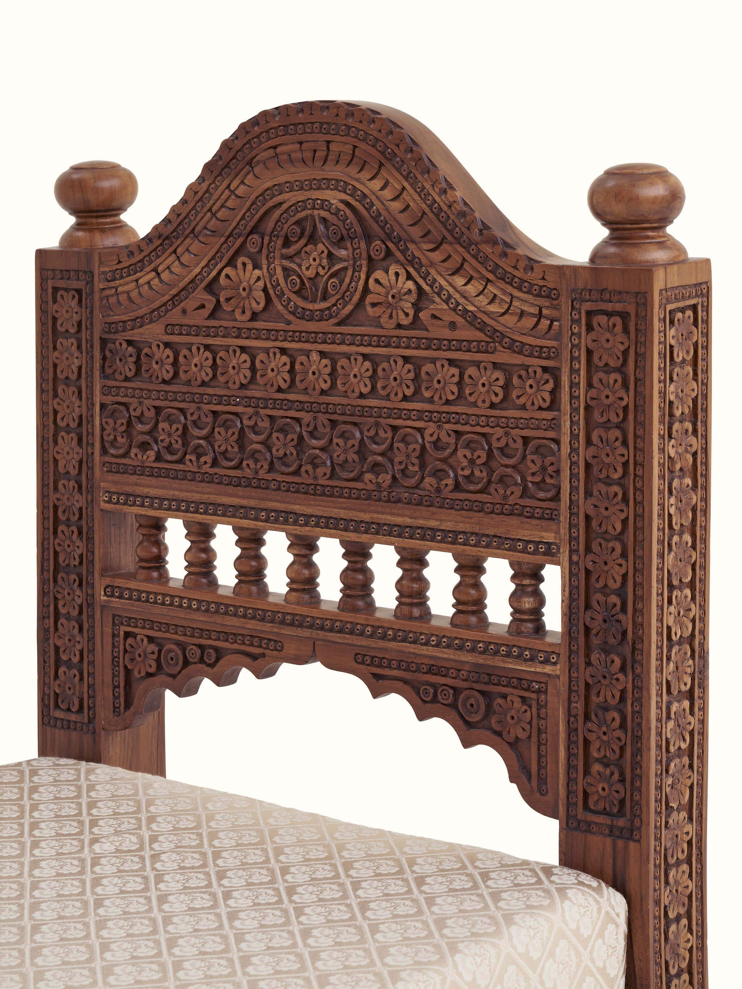 Side view of Carved Sheesham wood upholstered sofa highlighting the detailed carvings and side upholstery