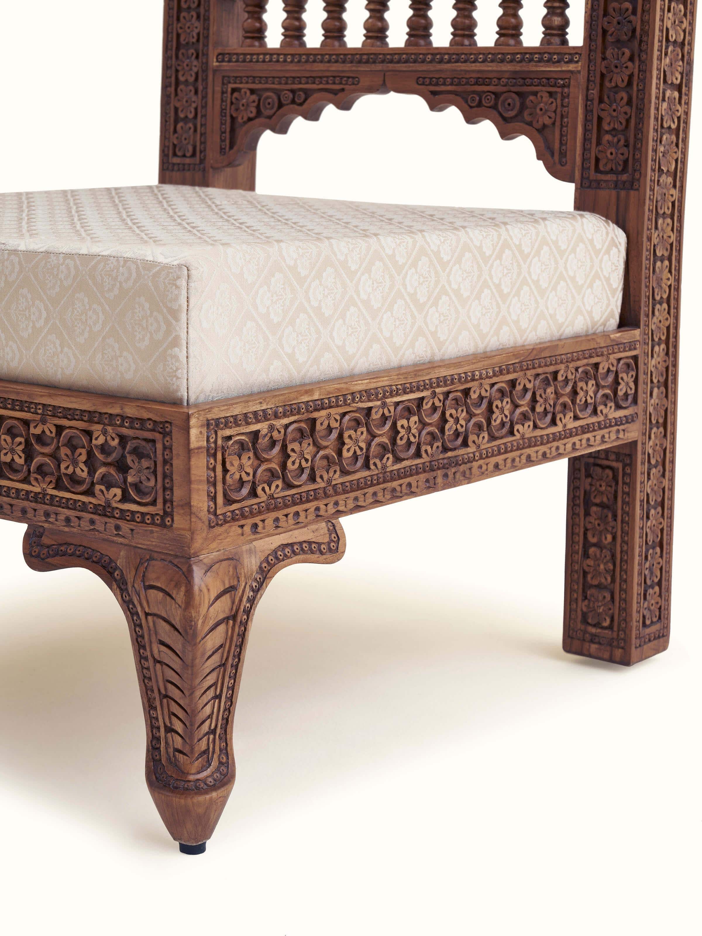 Back view of Carved Sheesham wood upholstered sofa, showing the carved details and overall design
