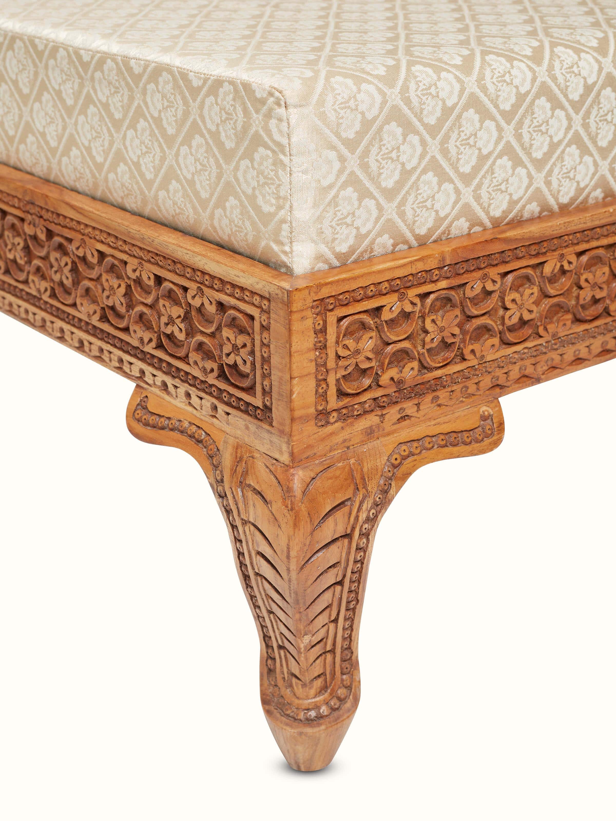 Side view of the upholstered Sheesham wood sofa, focusing on the wood carvings and upholstered cushions