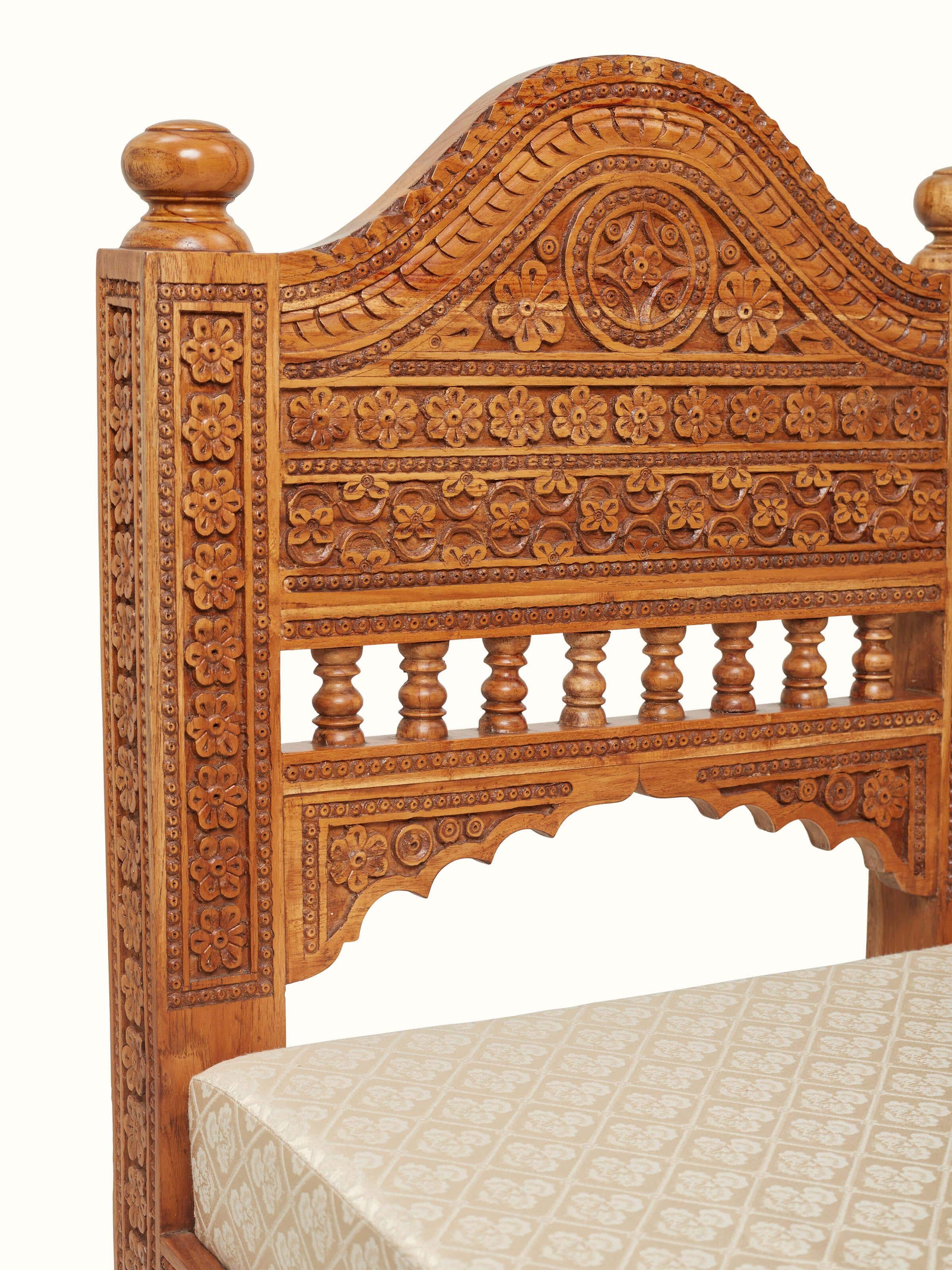 Detailed view of the sofa’s upholstery and carved wooden legs, highlighting the craftsmanship and design