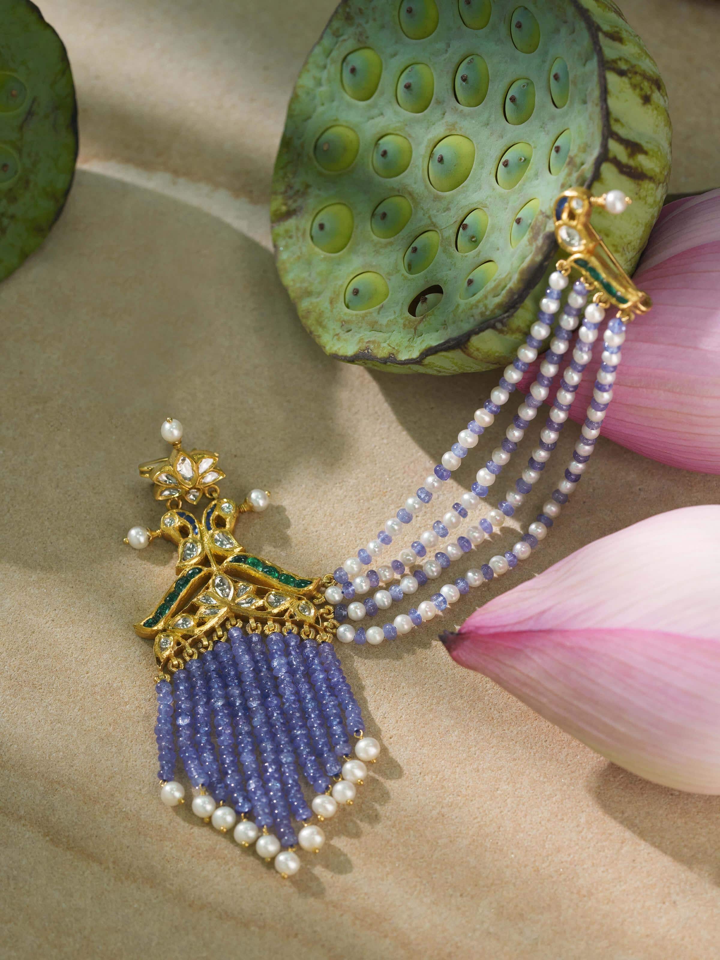 Lifestyle image of Jadau 18 Karat gold brooch pin pinned on traditional wear for a royal accent.