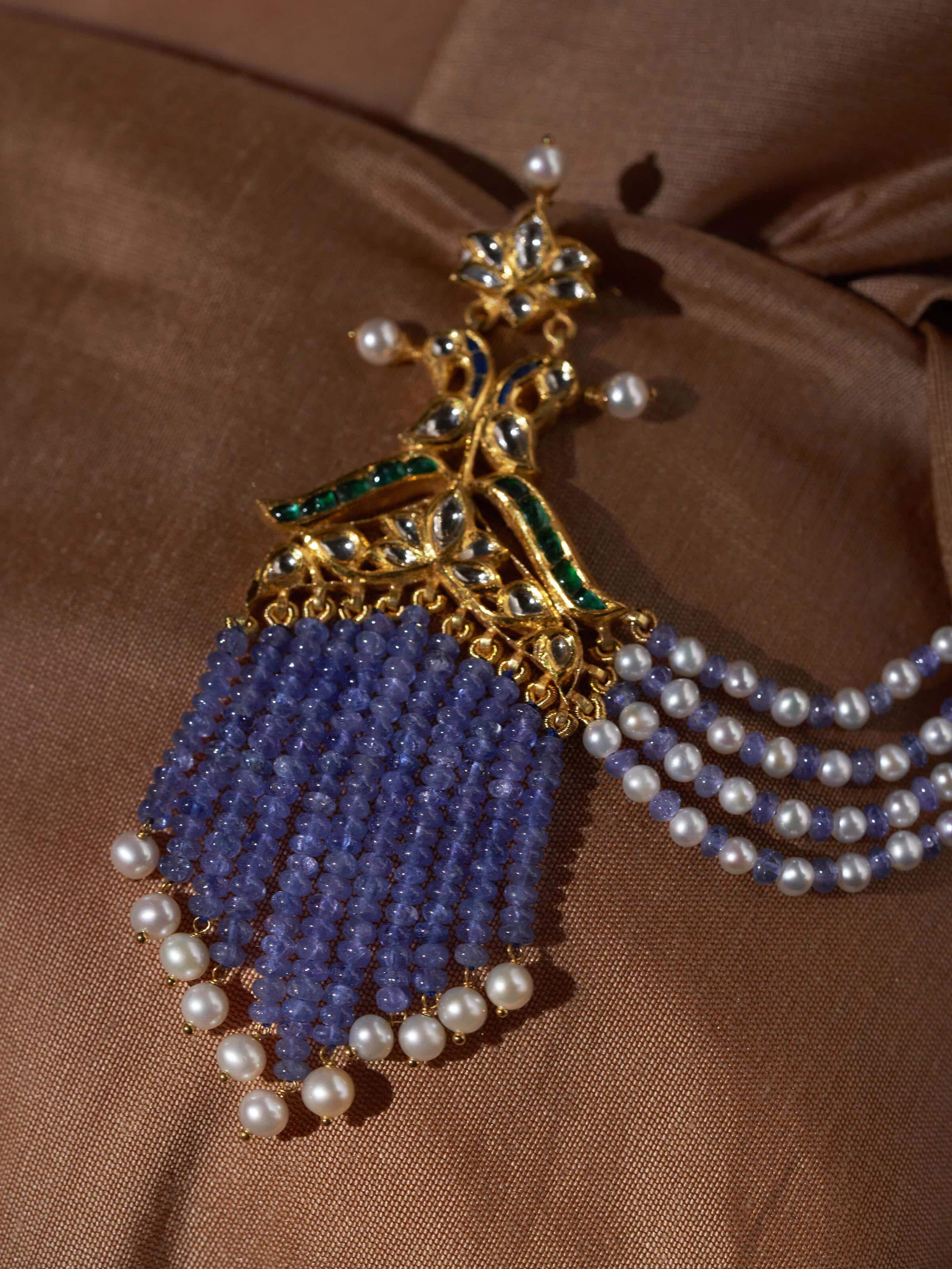 Angled view of Jadau 18 Karat gold brooch pin highlighting depth and traditional Jadau artistry.