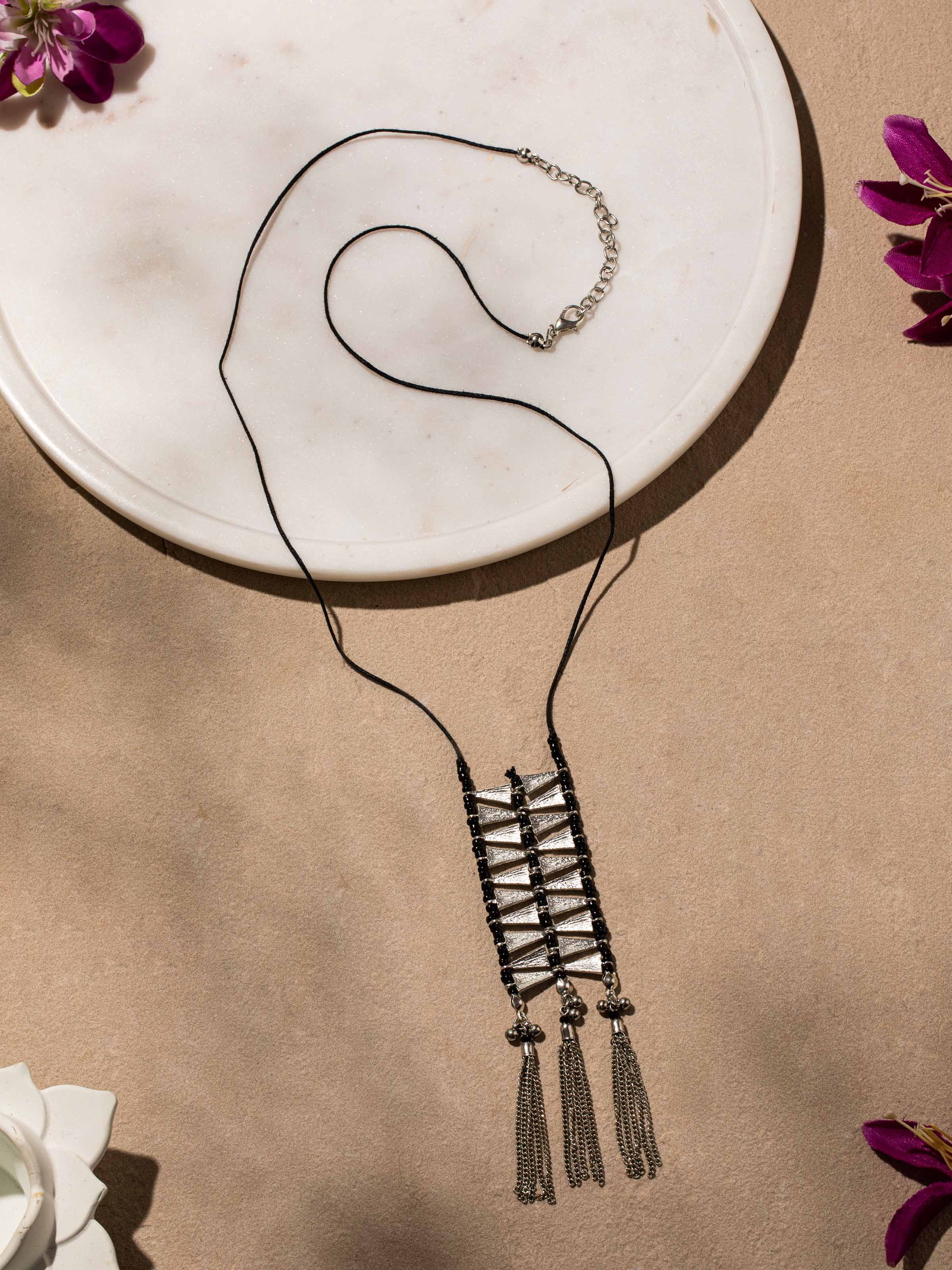 Side view of silver smithing drop earrings showcasing intricate silverwork and detailed design.