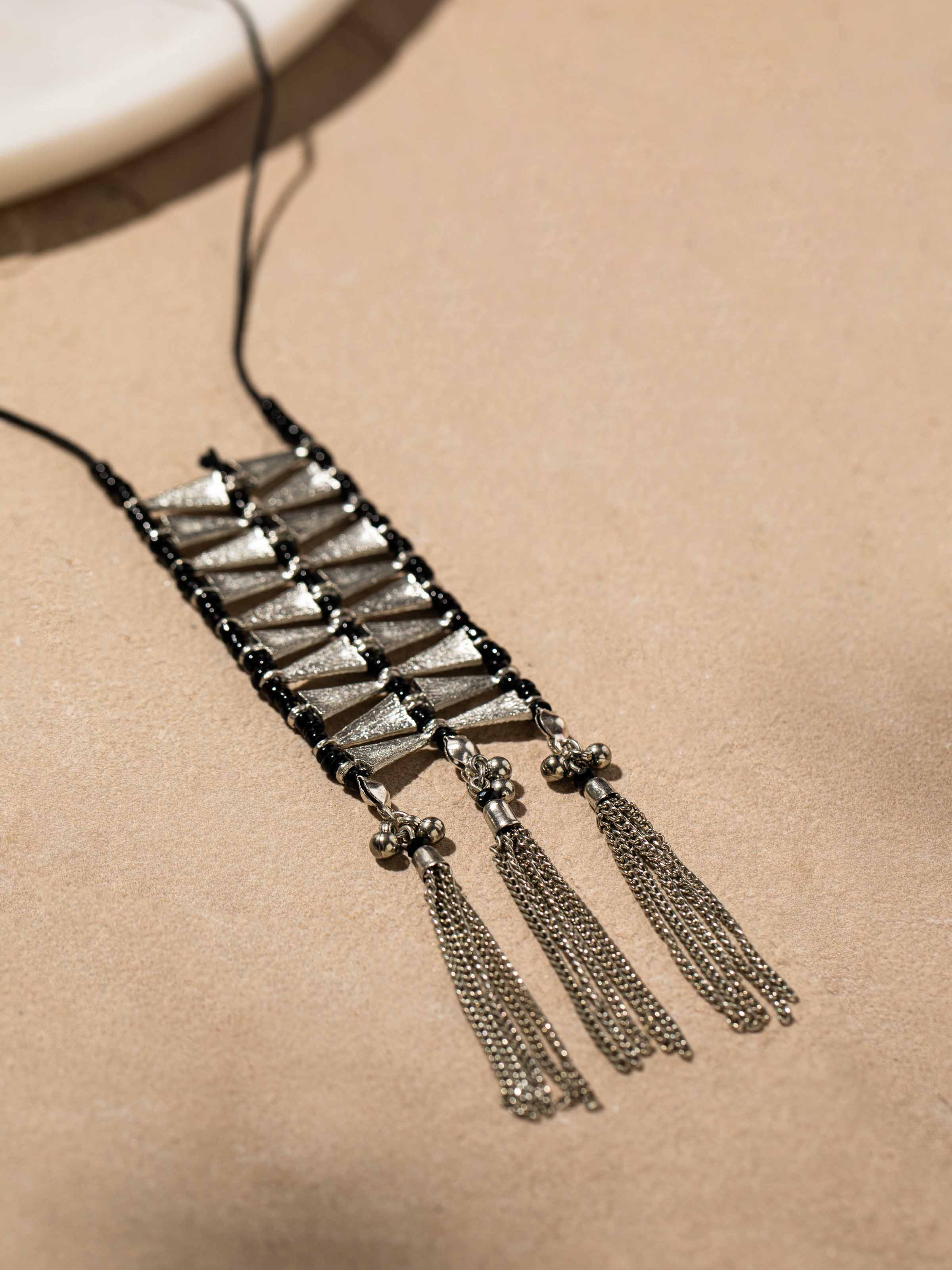 Back view of silver smithing drop earrings showing the secure clasp and overall design.