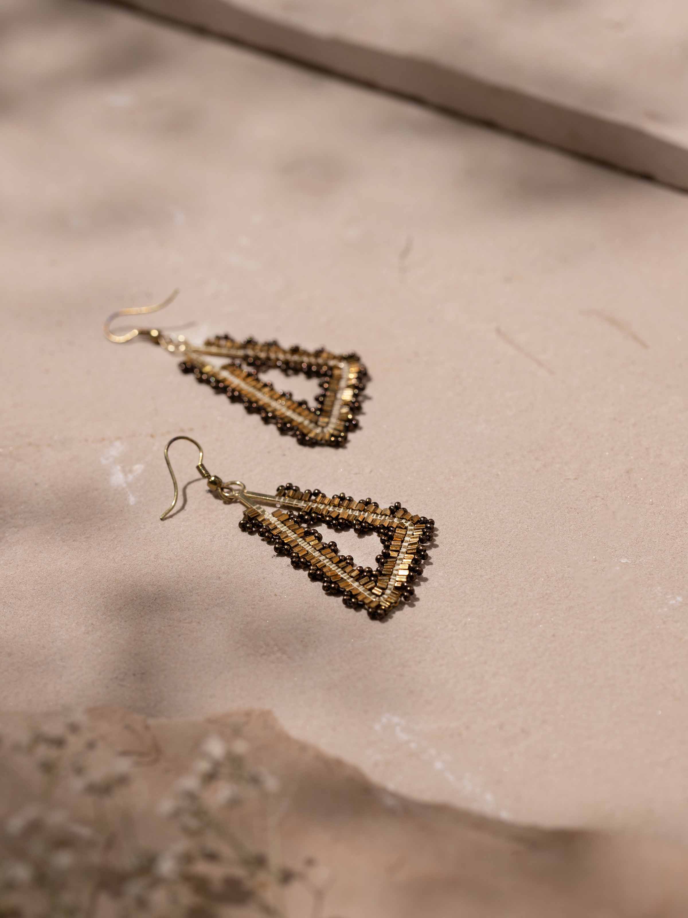 Handcrafted drop earrings displayed in a box to showcase their presentation and fine design.