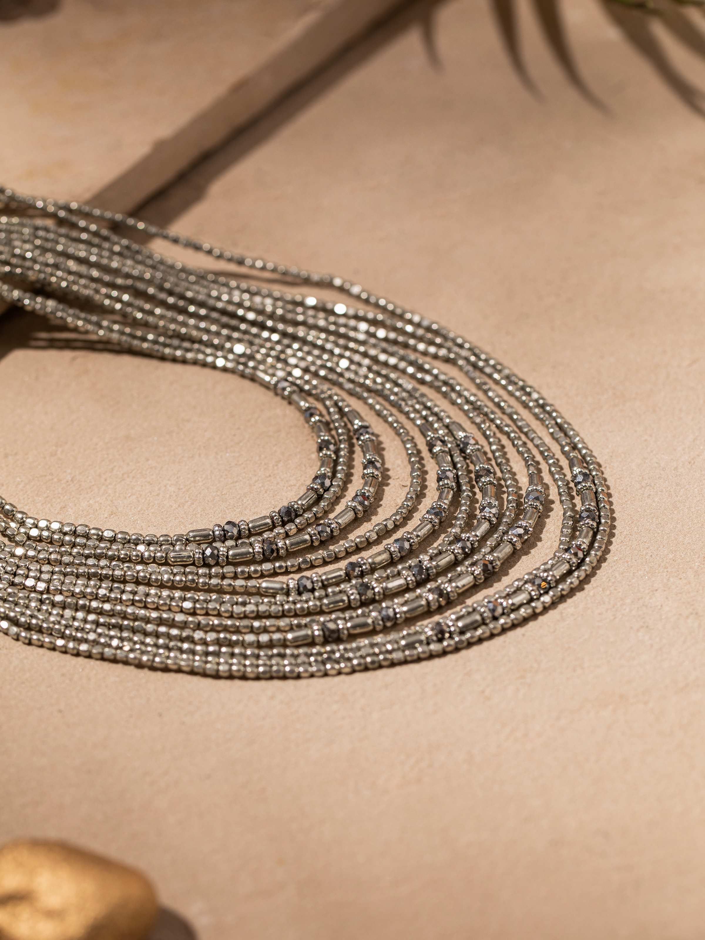 Detailed close-up of handcrafted collar necklace showing texture and intricate design elements