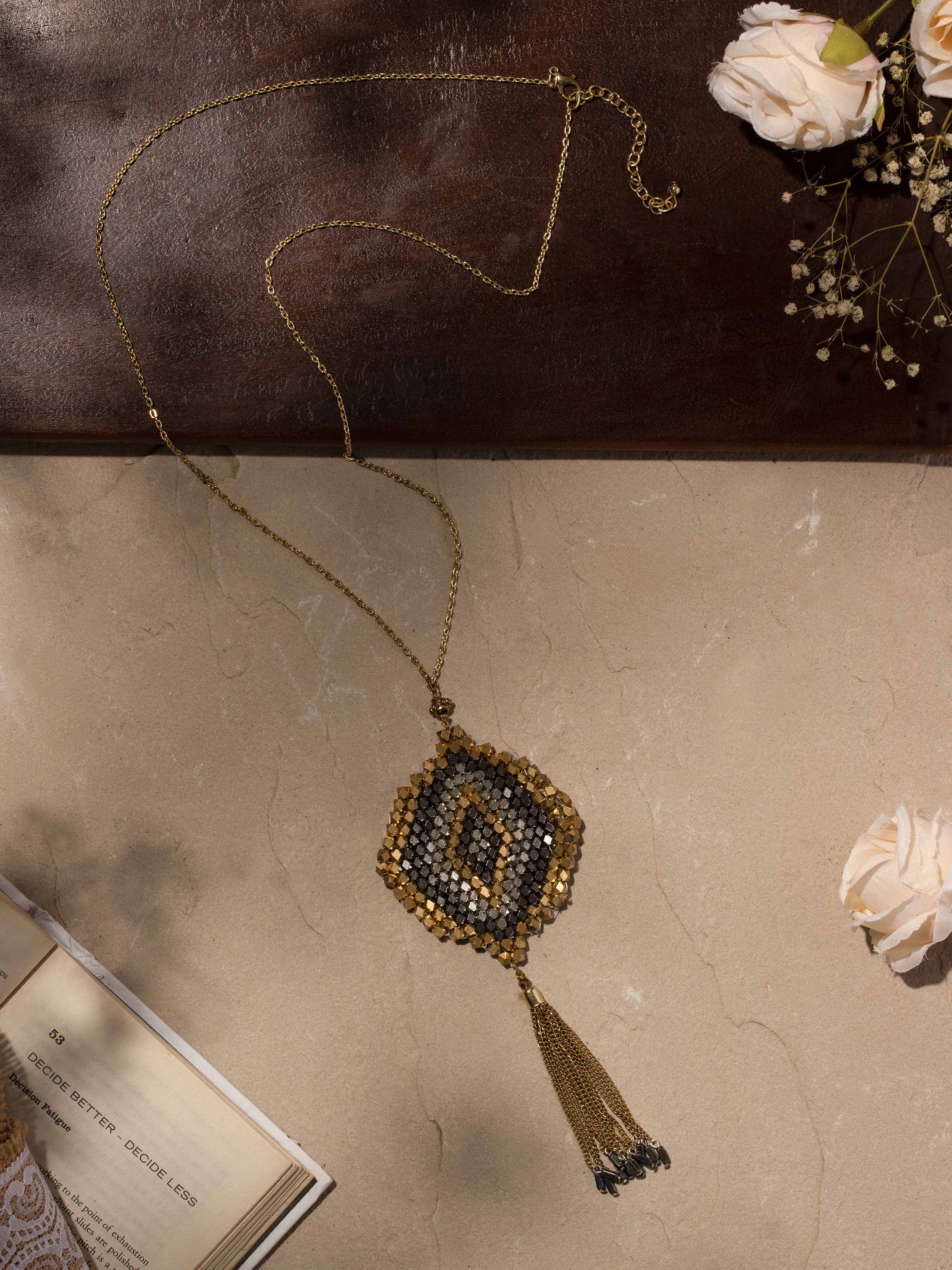 Close-up view of handcrafted long necklace emphasizing its fine craftsmanship and decorative elements