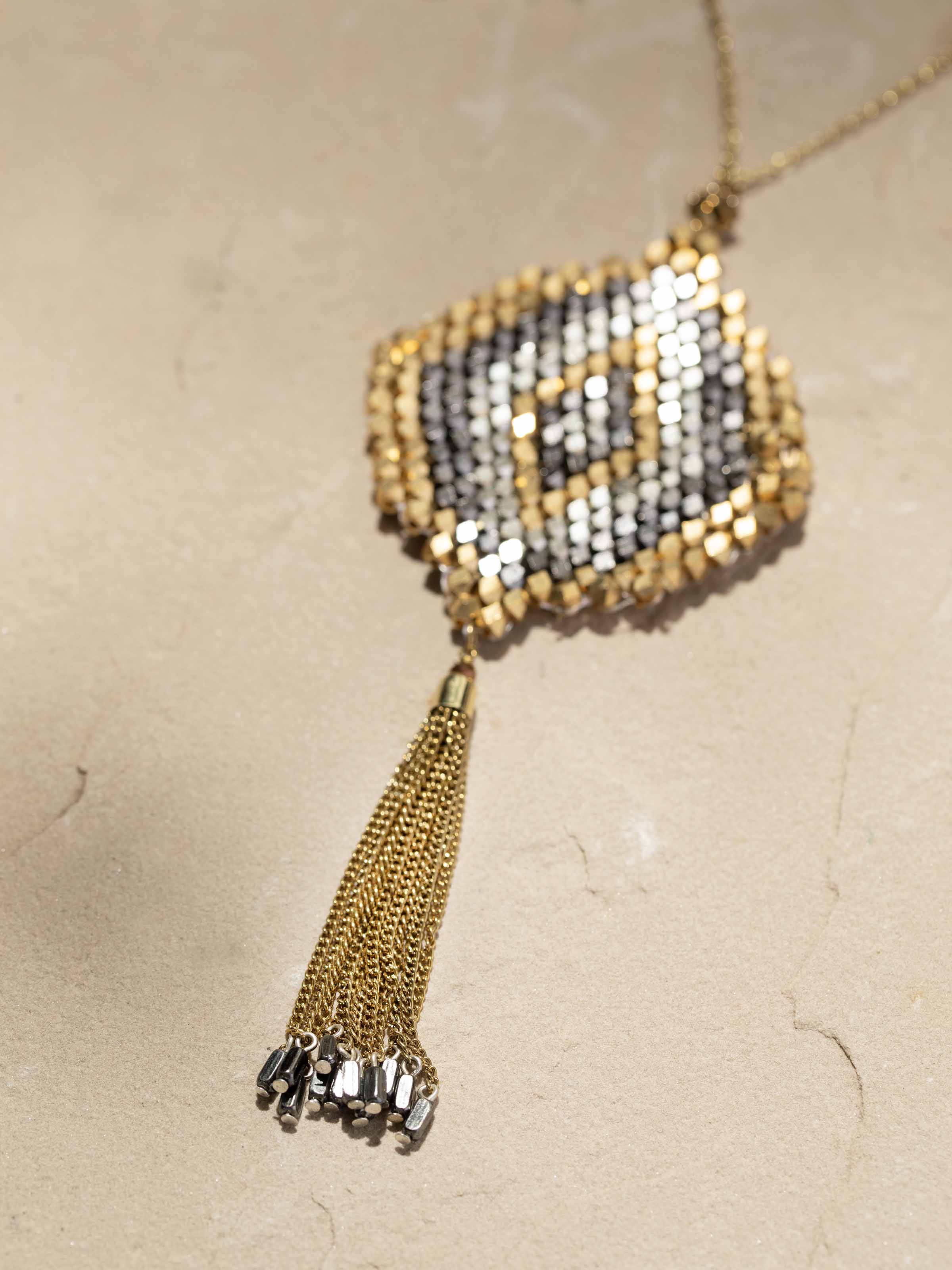 Detailed view of handcrafted long necklace highlighting its vibrant beadwork and traditional craftsmanship