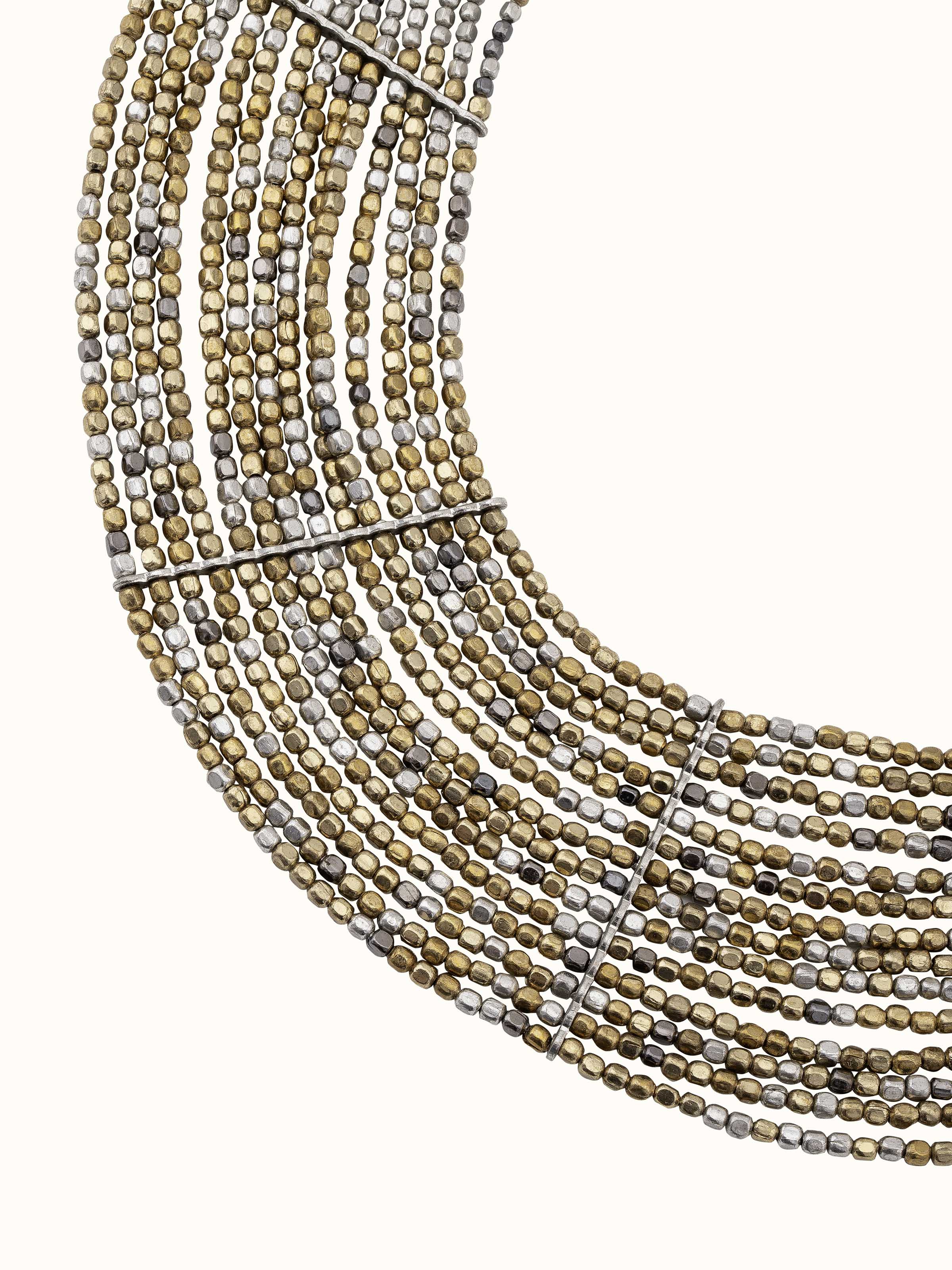 Overhead view of handcrafted long necklace featuring intricate design and artistic embellishments