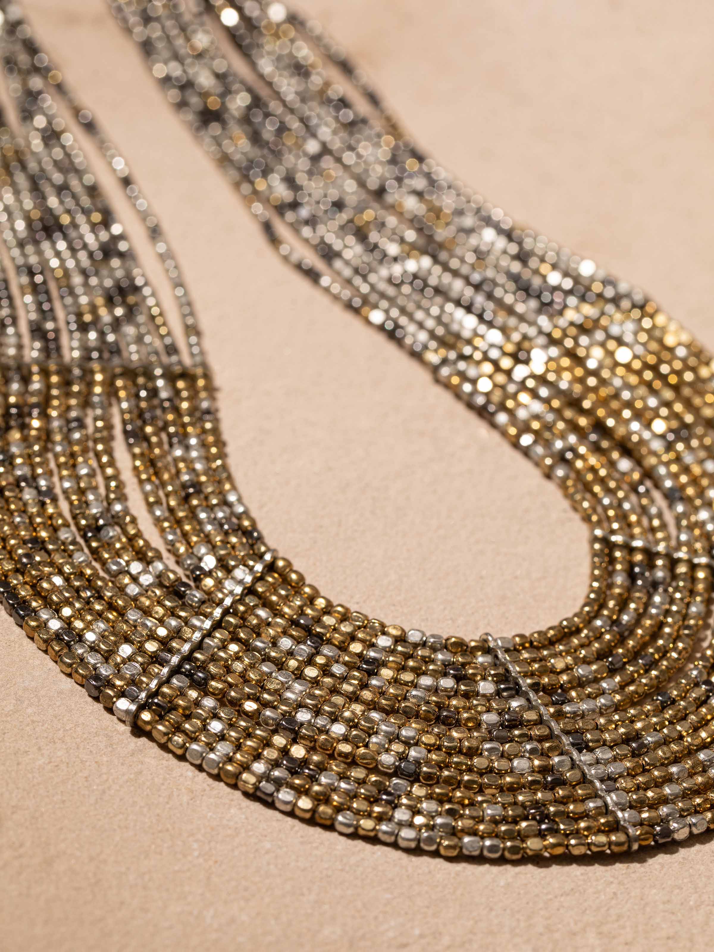 Detailed shot of handcrafted long necklace with emphasis on beadwork and elegant design