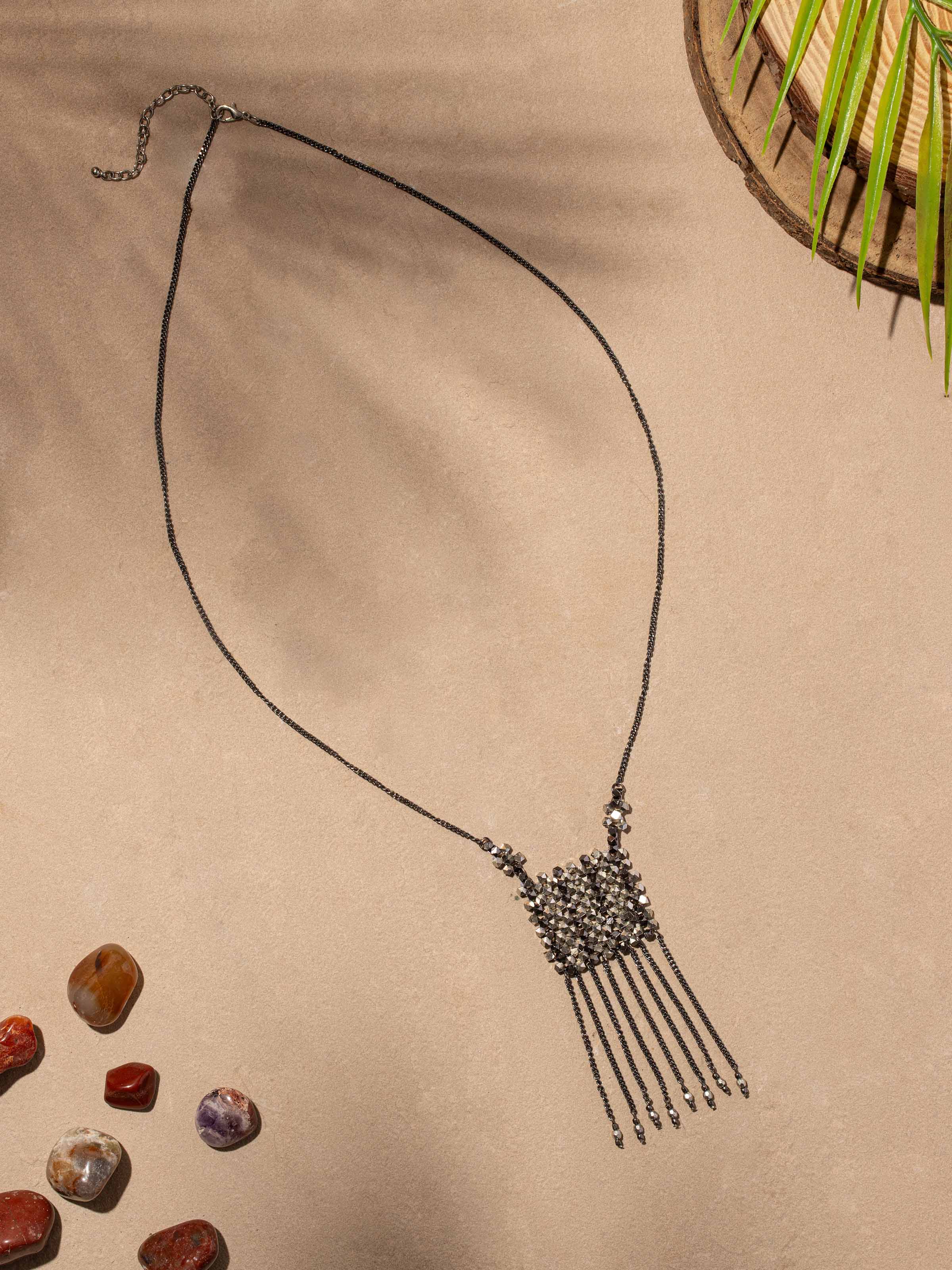 Side view of handcrafted long necklace showcasing design and texture