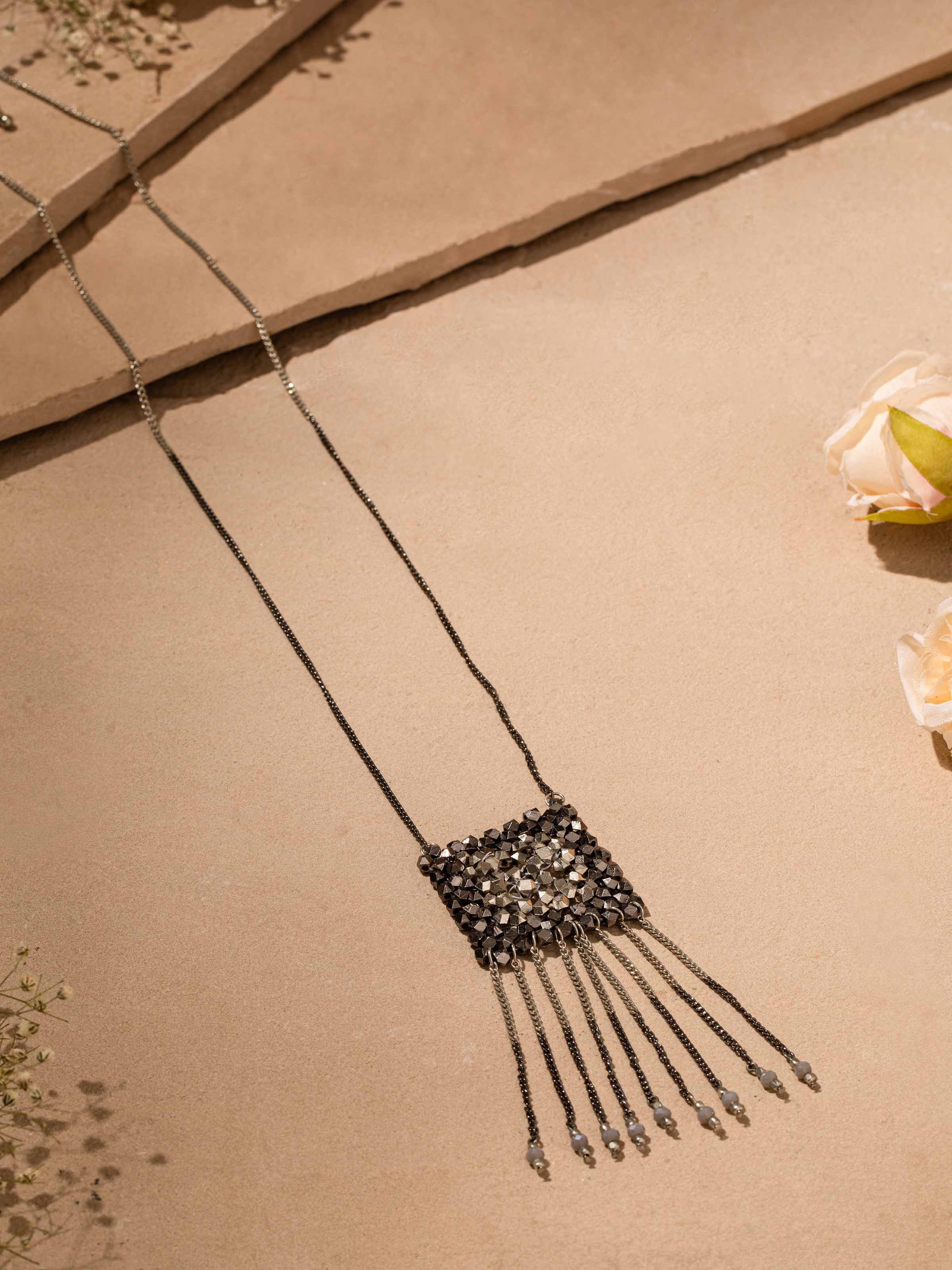 Close-up view of Handcrafted long necklace focusing on its fine details and craftsmanship