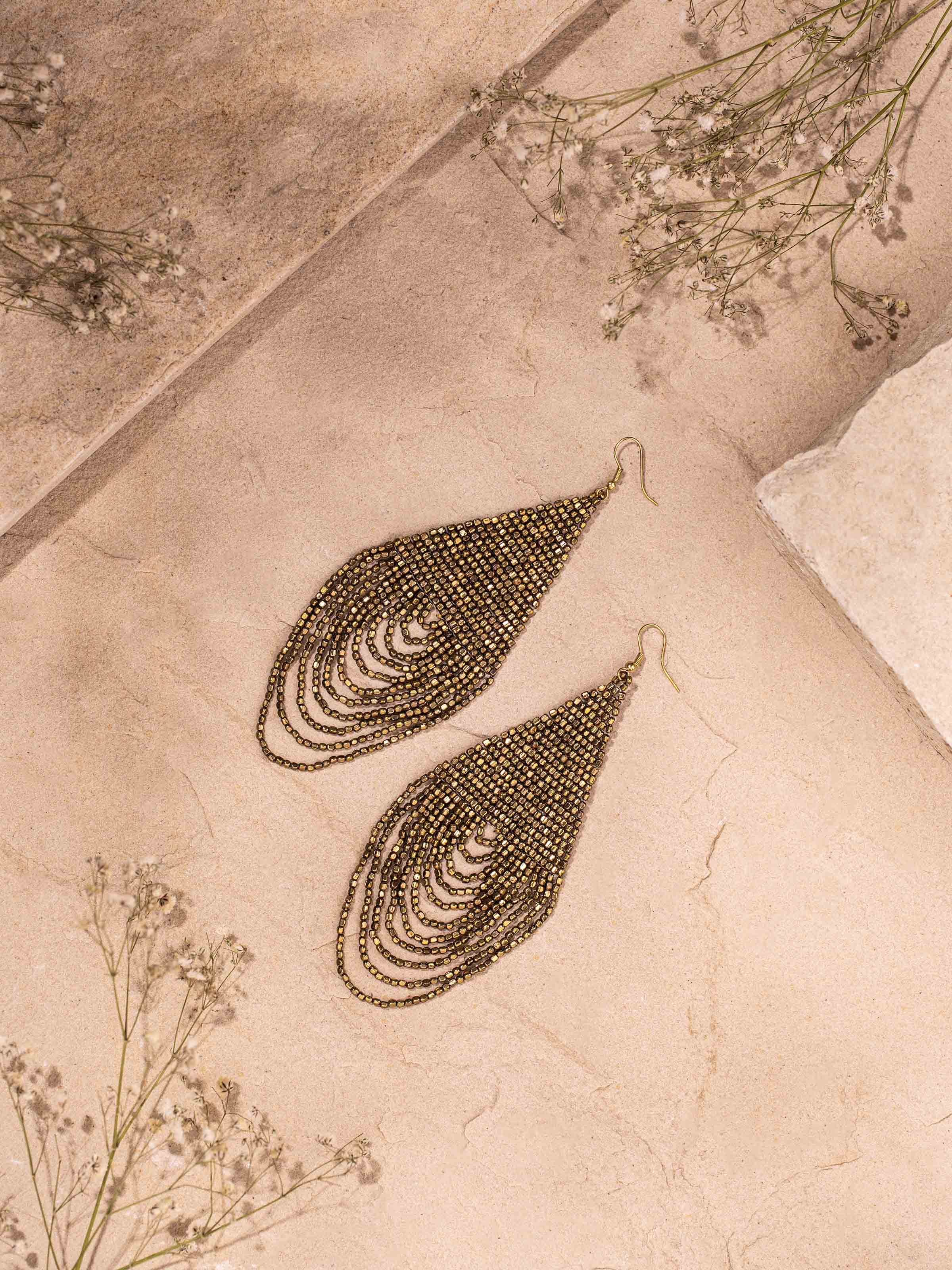 Close-up of handcrafted drop earrings highlighting intricate details and finishes.