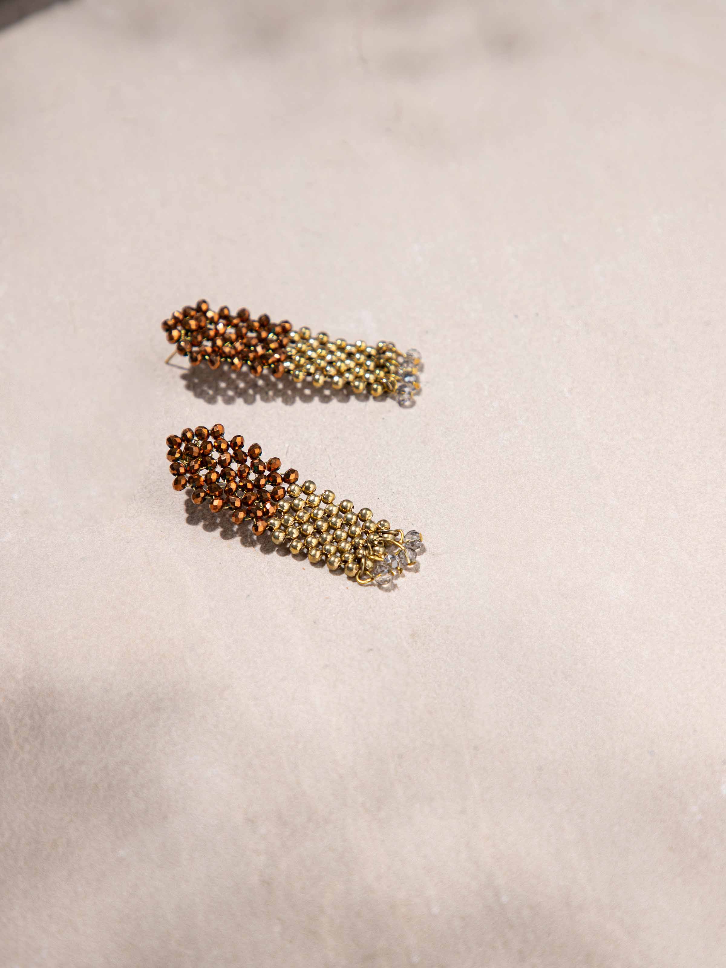 Overhead view of Handcrafted Drop Earrings showcasing elegant drop design and intricate metalwork.