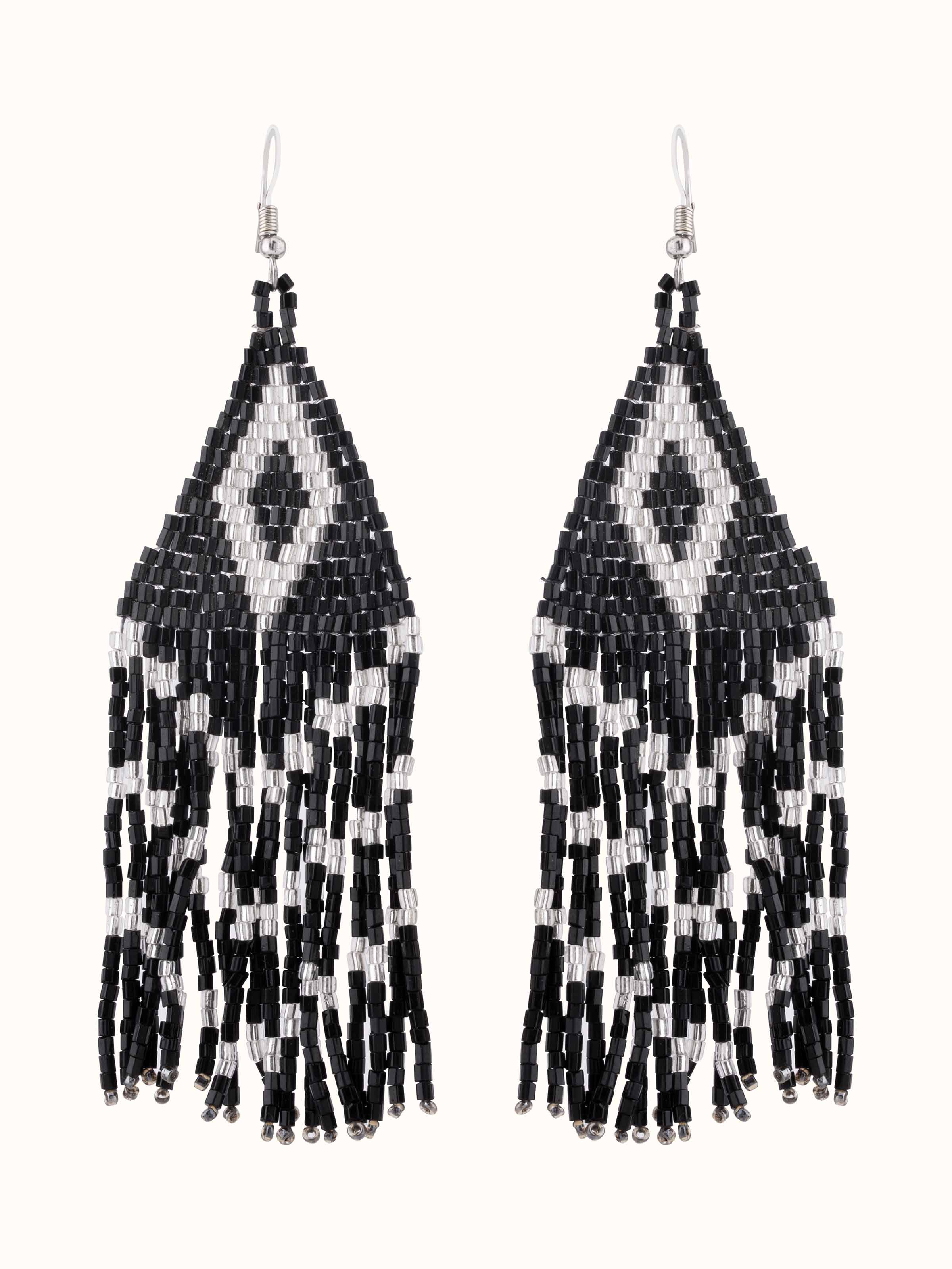 Front view of handcrafted drop earrings featuring intricate metalwork and design