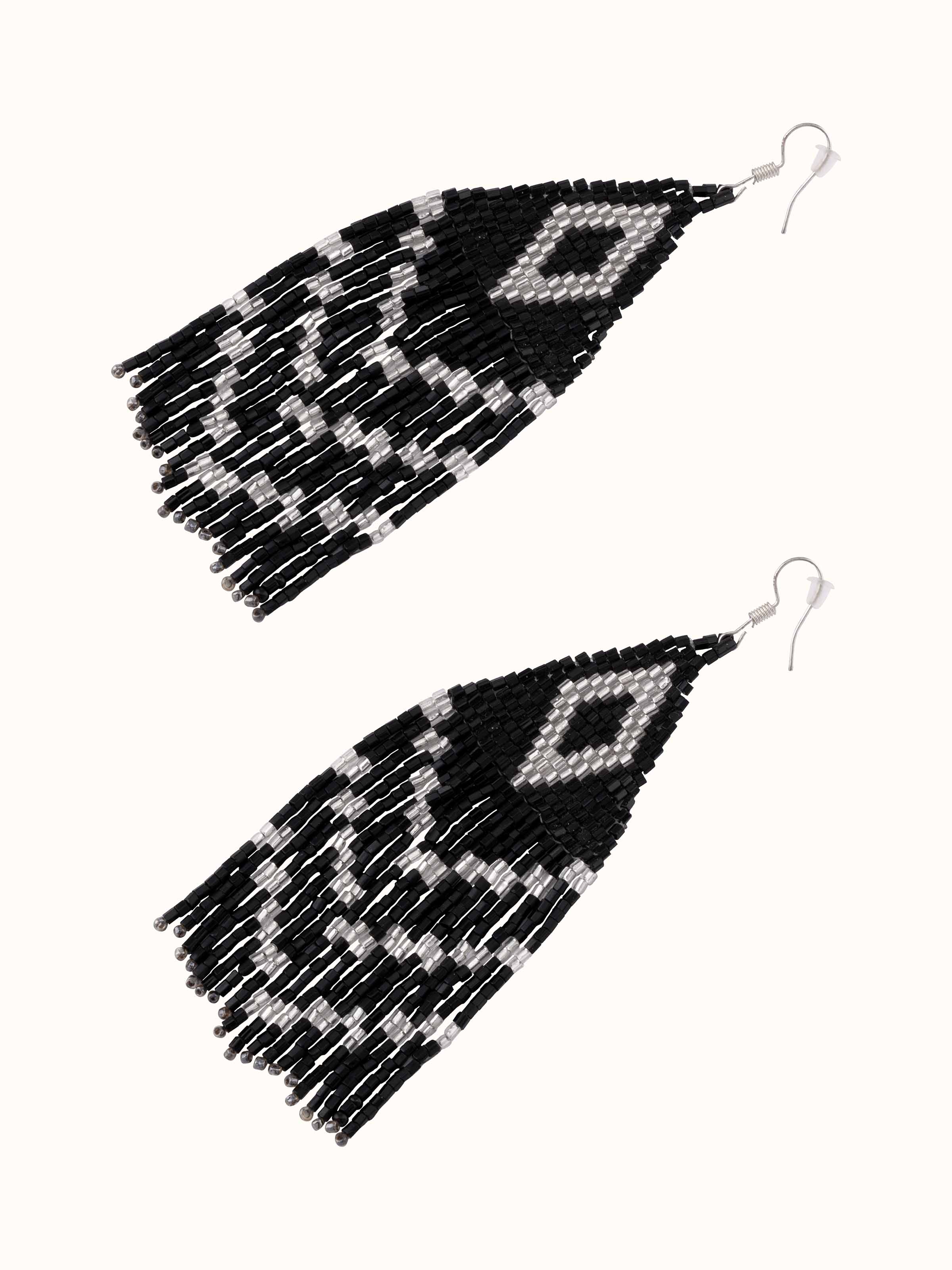 Detailed view of handcrafted drop earrings displaying unique design elements