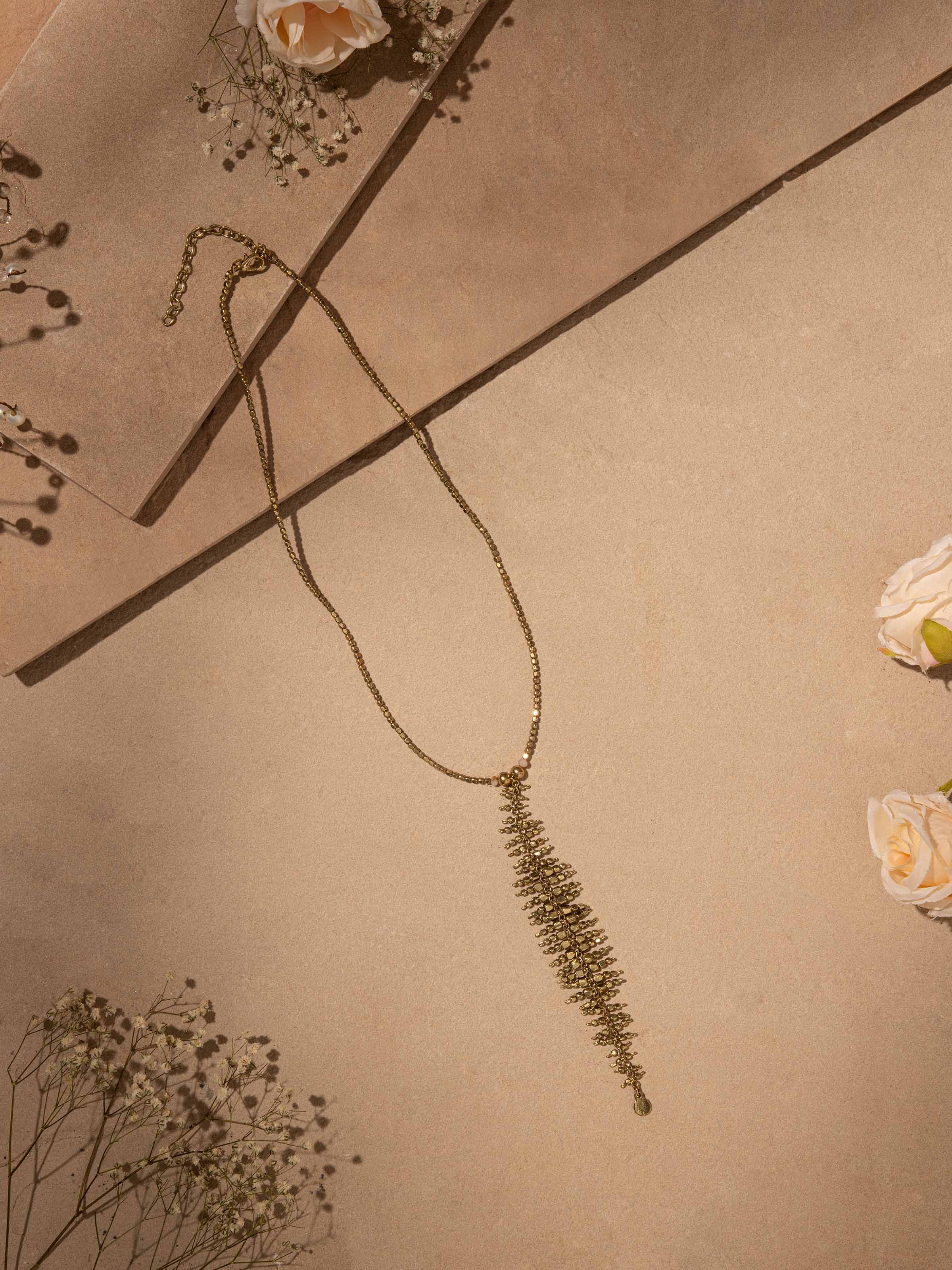 Close-up of handcrafted long necklace emphasizing fine craftsmanship and design