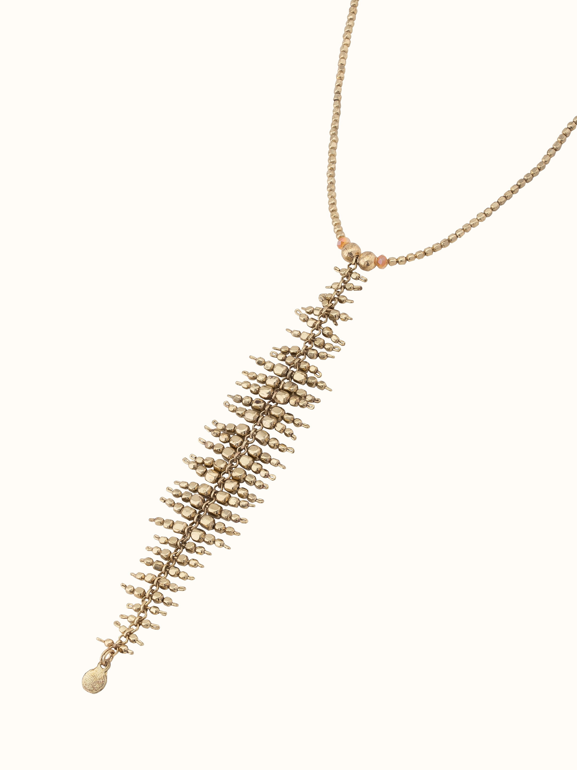 Overhead view of handcrafted long necklace featuring intricate details and unique design elements