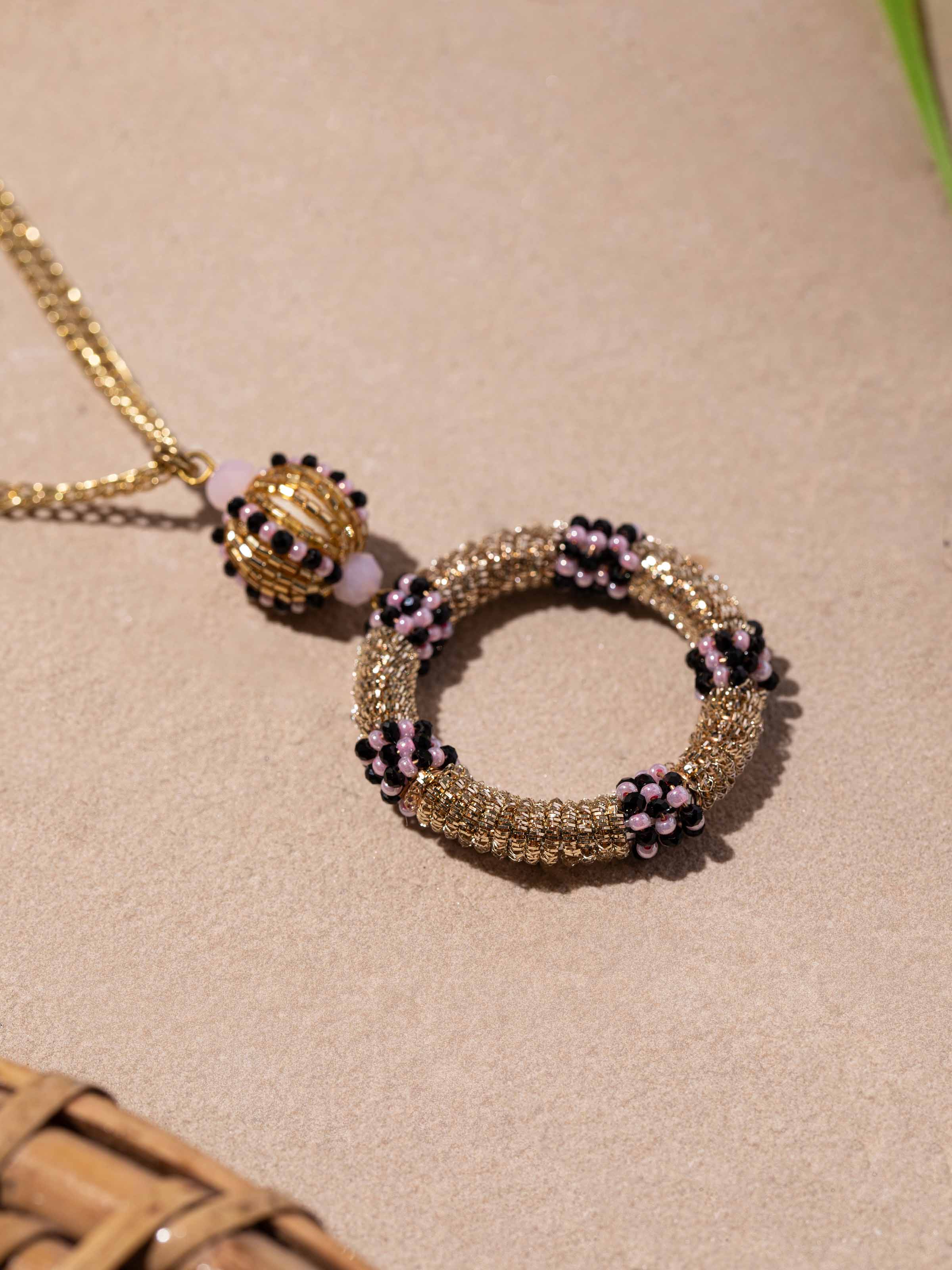 Side view of handcrafted long necklace showcasing detailed design.