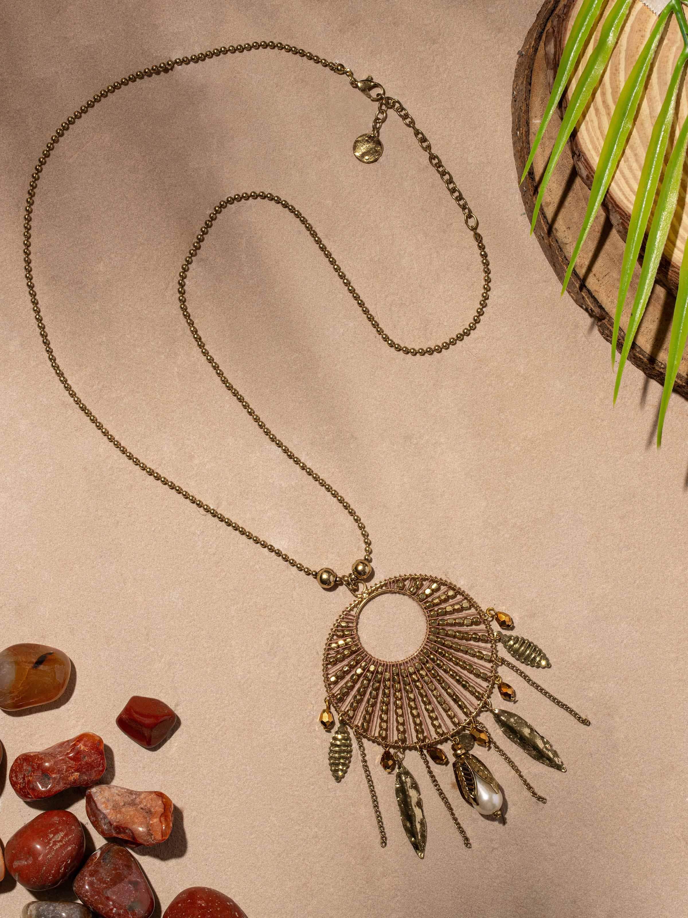 Close-up of handcrafted long necklace displaying intricate pendant details and vibrant color.