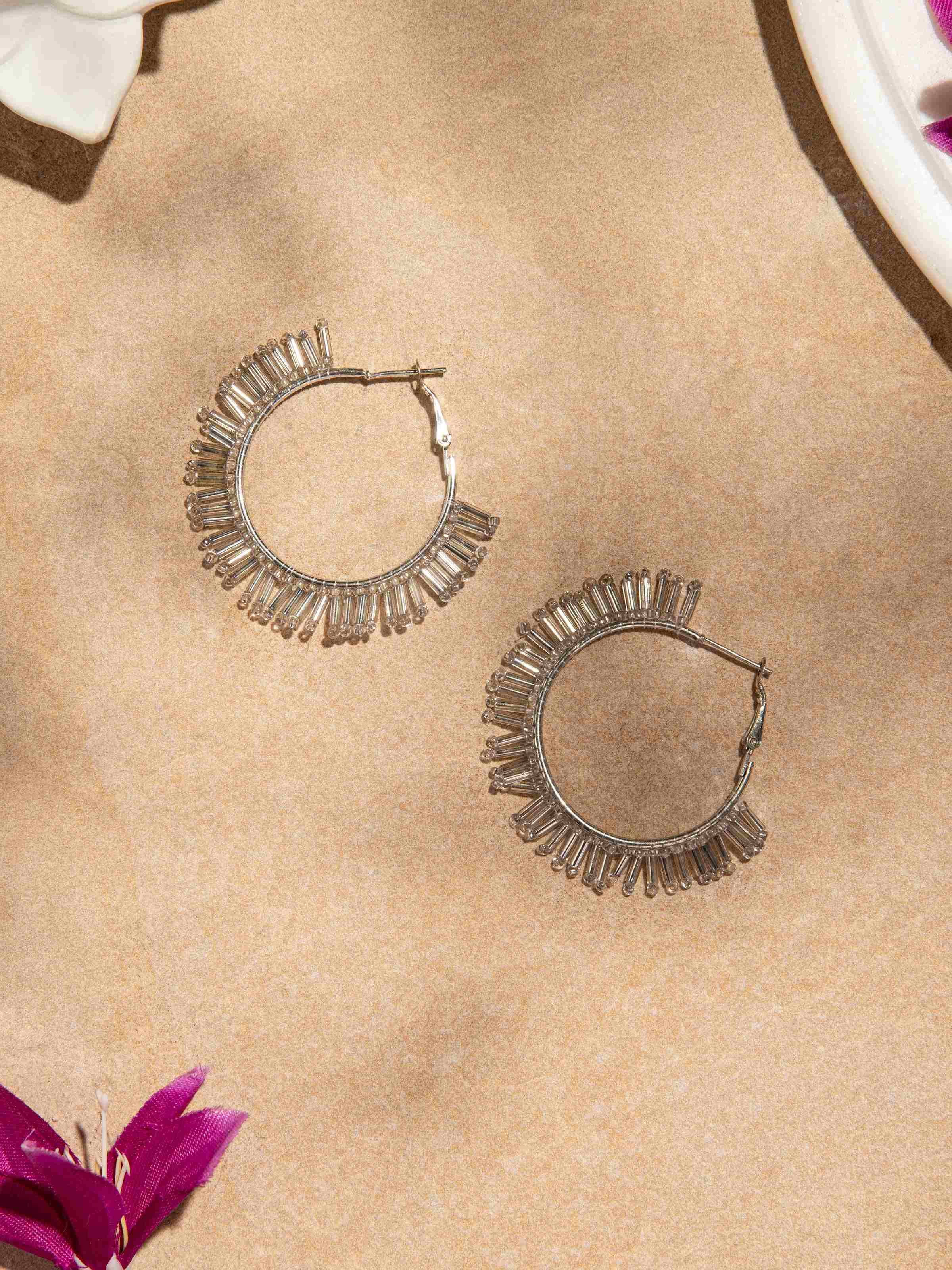 Side view of handcrafted hoop earrings showcasing the elegant design and detailed craftsmanship.