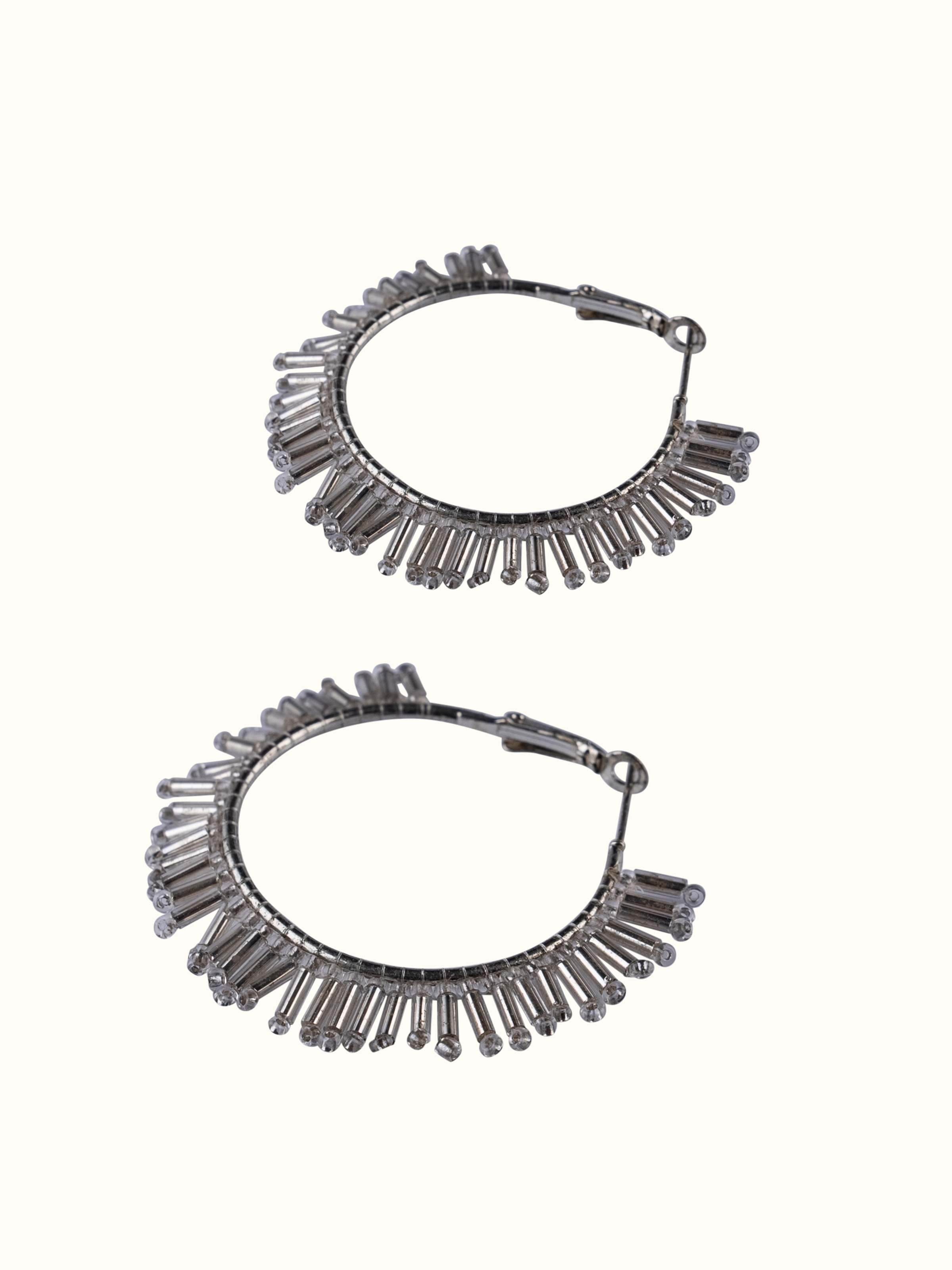 Detailed view of handcrafted hoop earrings focusing on their artistic design and fine craftsmanship.