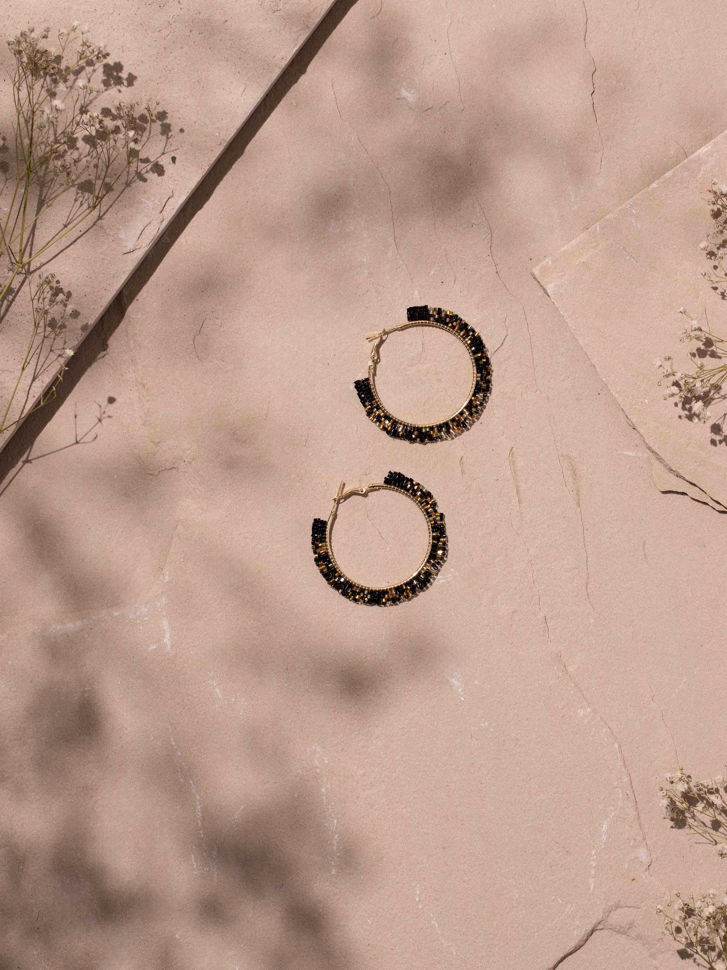 Angled view of handcrafted hoop earrings highlighting the high-quality finish and style.