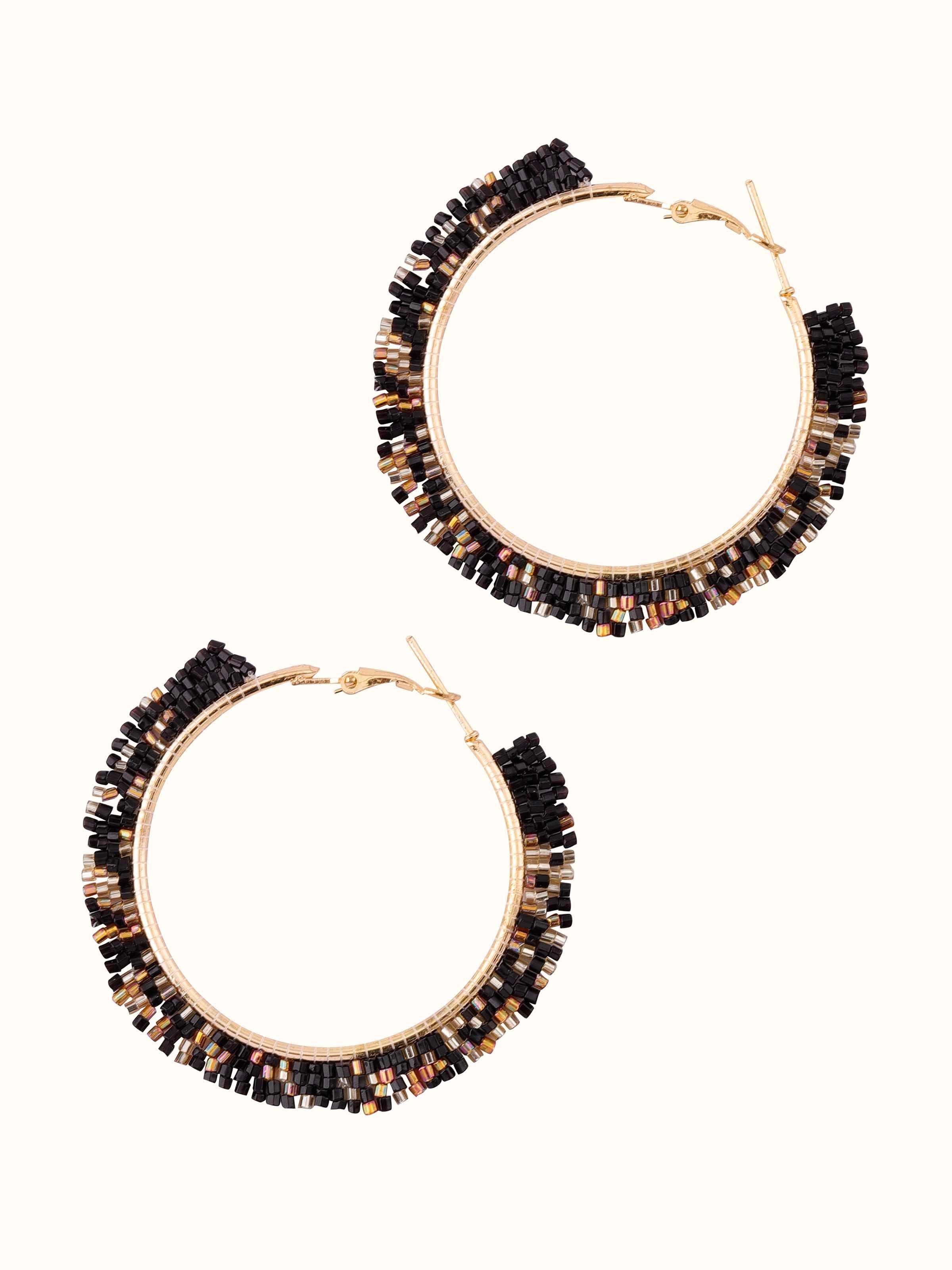 Detailed view of handcrafted hoop earrings focusing on the precise metalwork and elegant design.