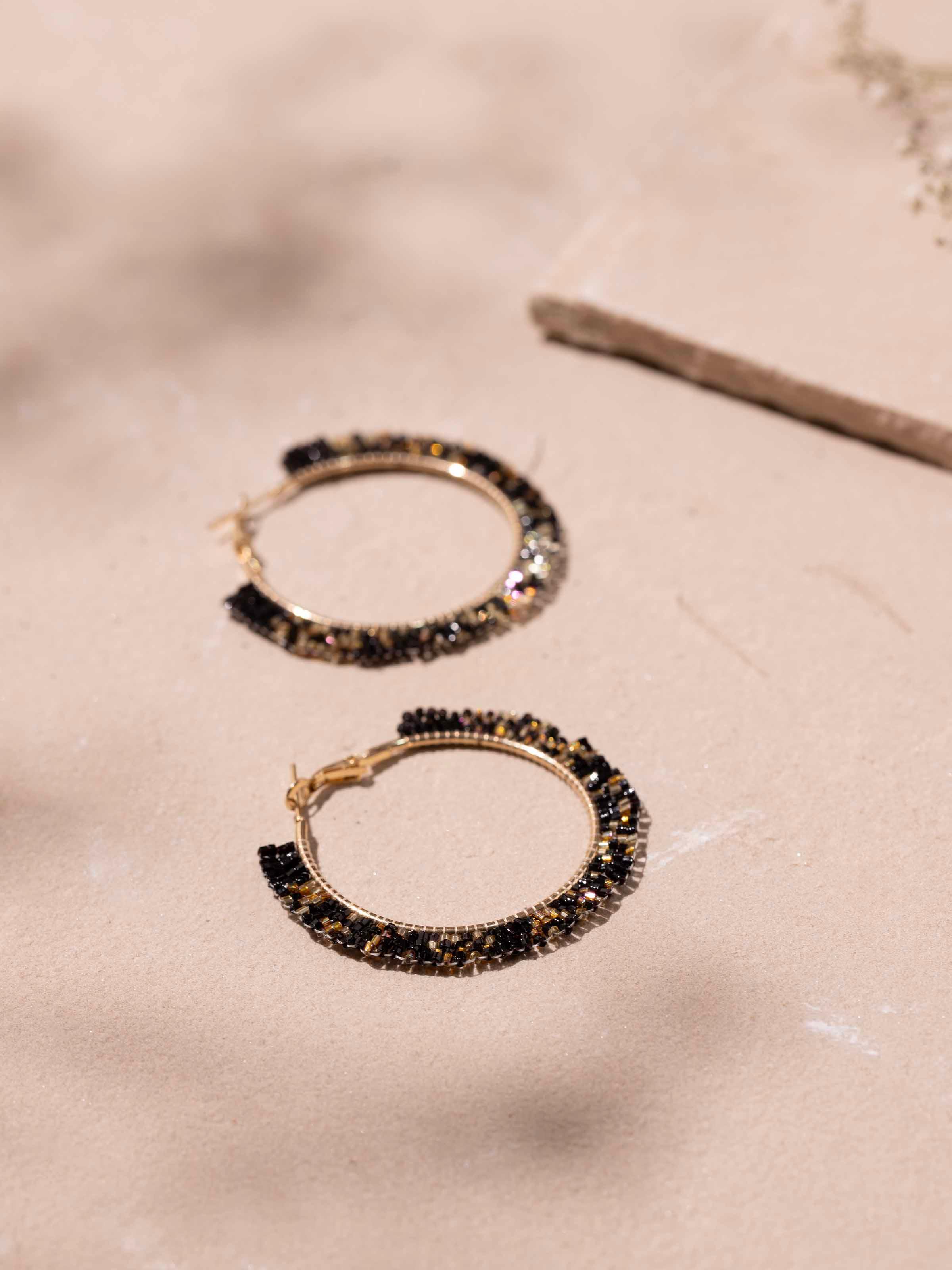 Back view of handcrafted hoop earrings showing the secure fastening and overall design.
