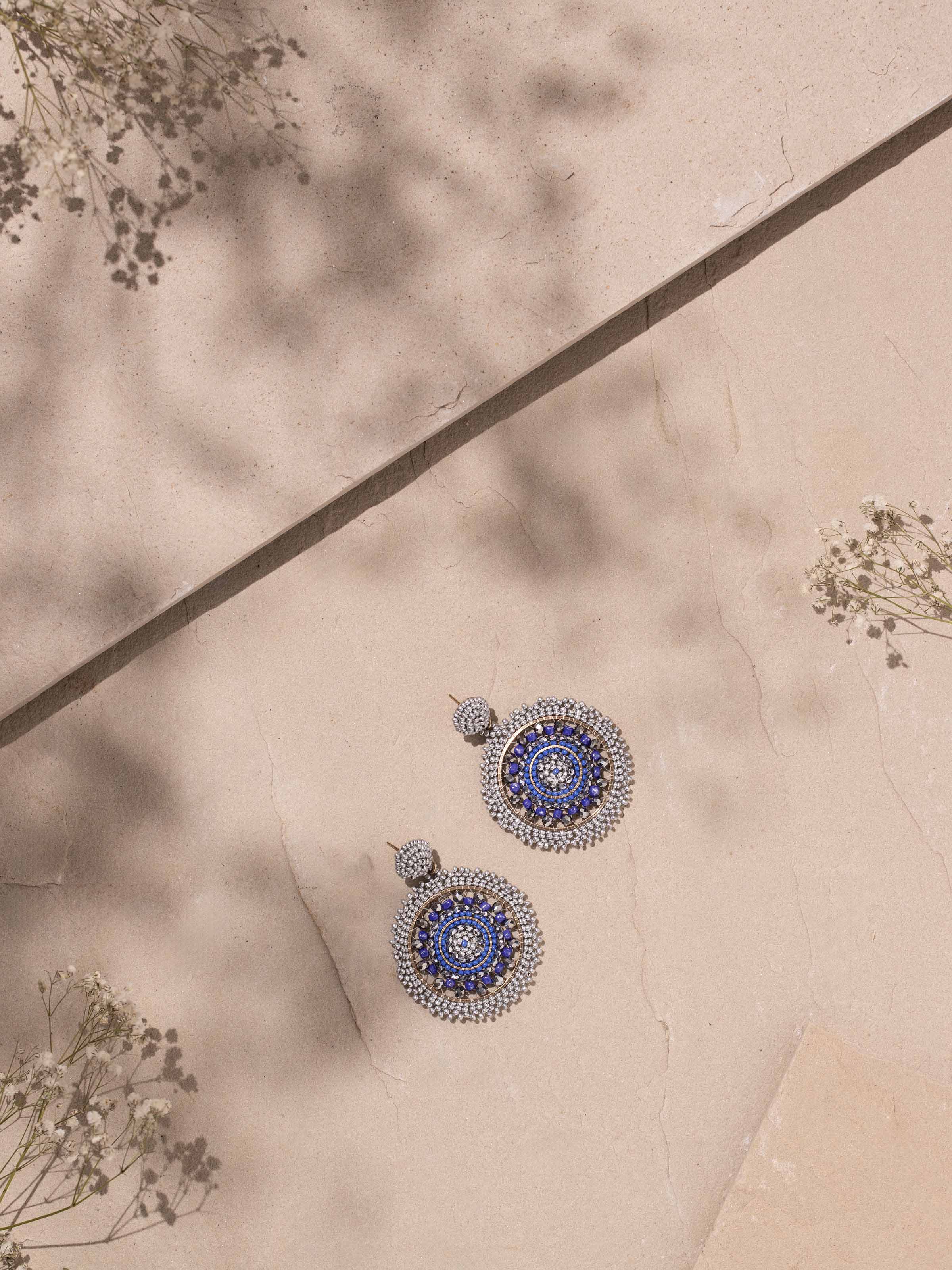 Side view of handcrafted drop earrings showcasing their detailed embellishments