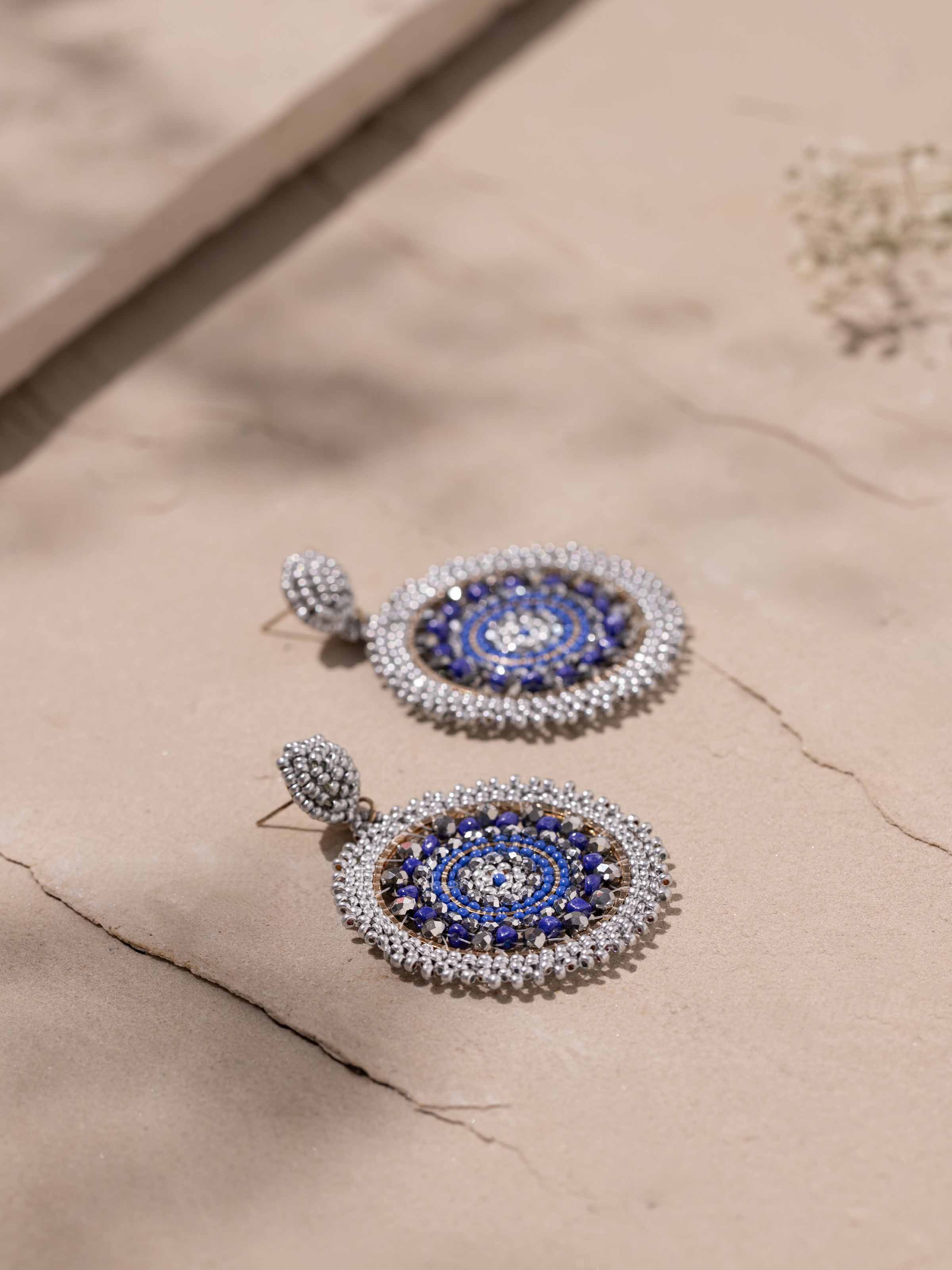 Detailed front view of handcrafted drop earrings emphasizing their artisanal finish