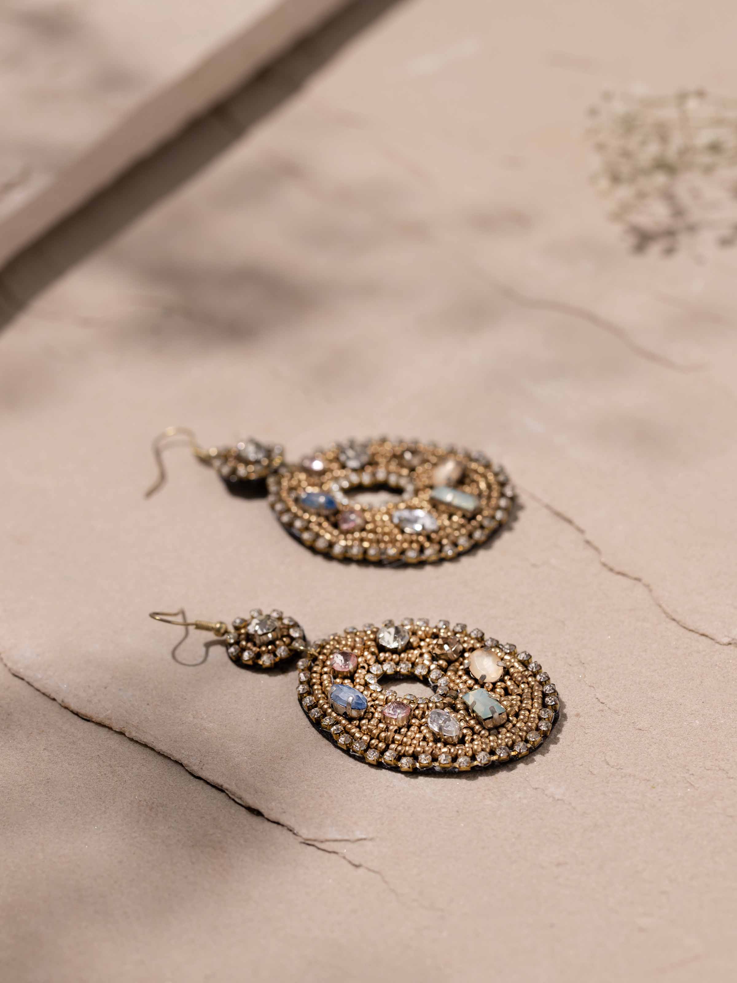 Detailed front view of handcrafted drop earrings showcasing their elegant design and color