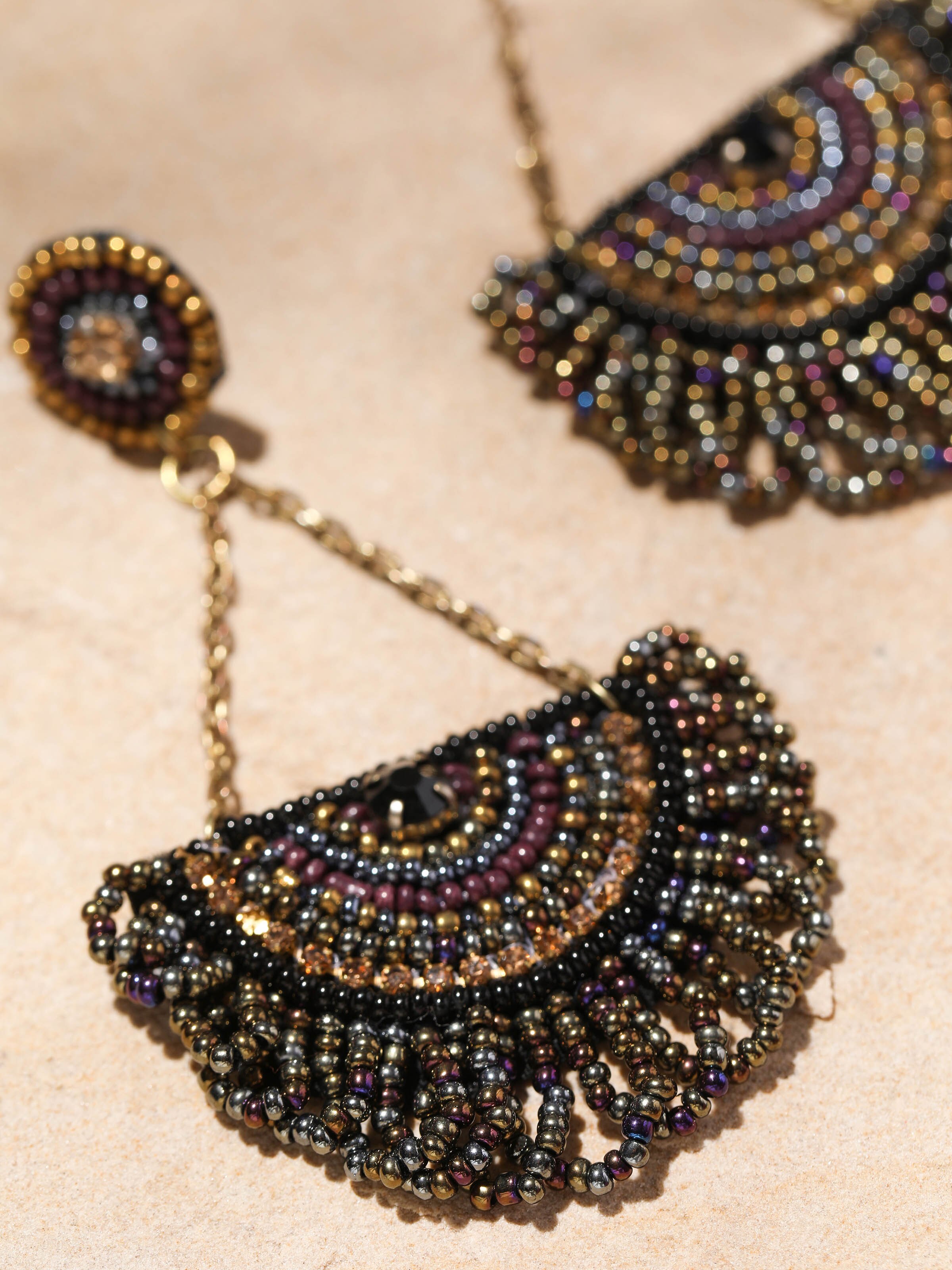 Overhead view of handcrafted drop earrings displaying overall design and elegance