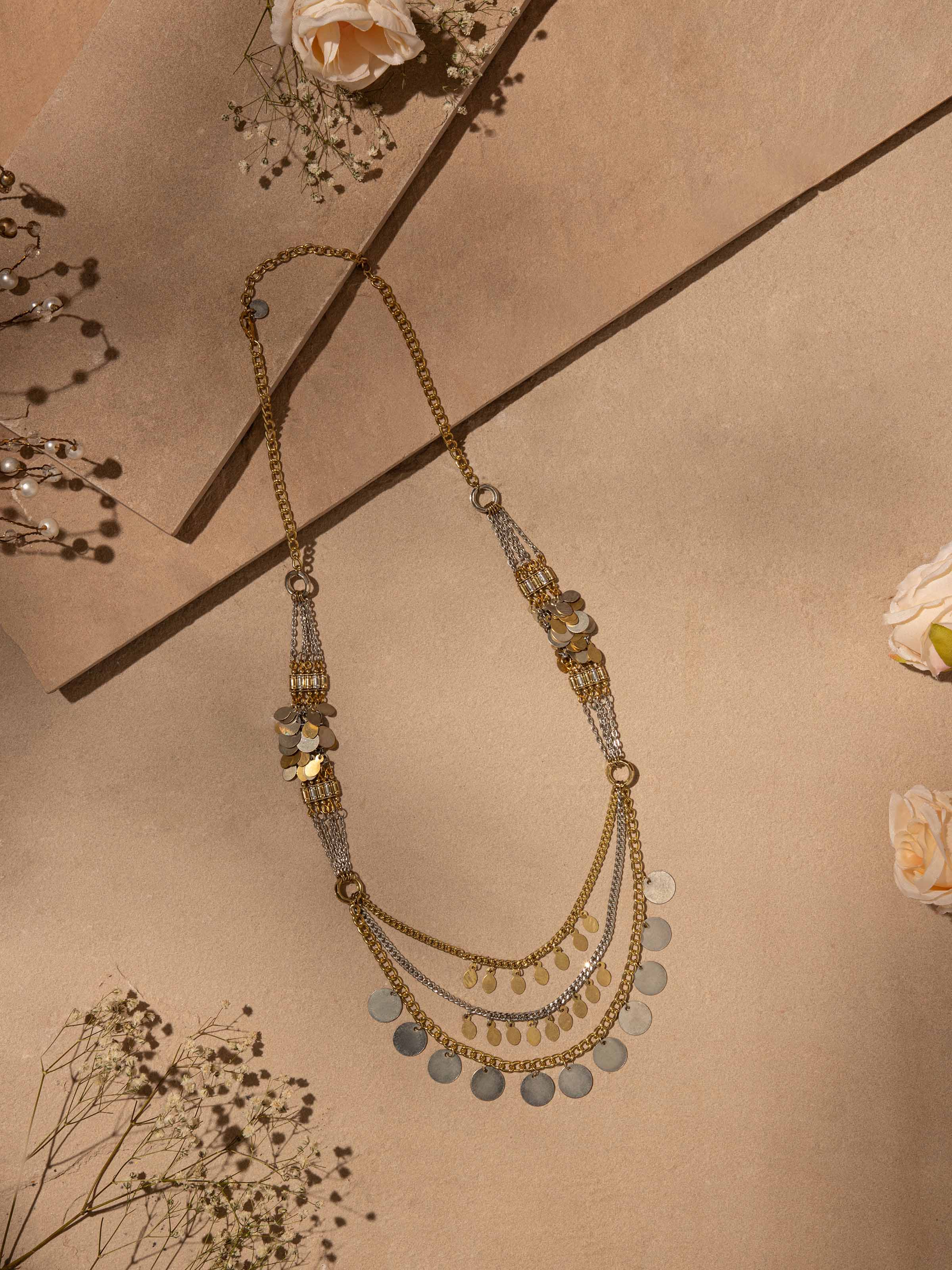 Close-up view of handcrafted long necklace highlighting detailed patterns and artistic design.