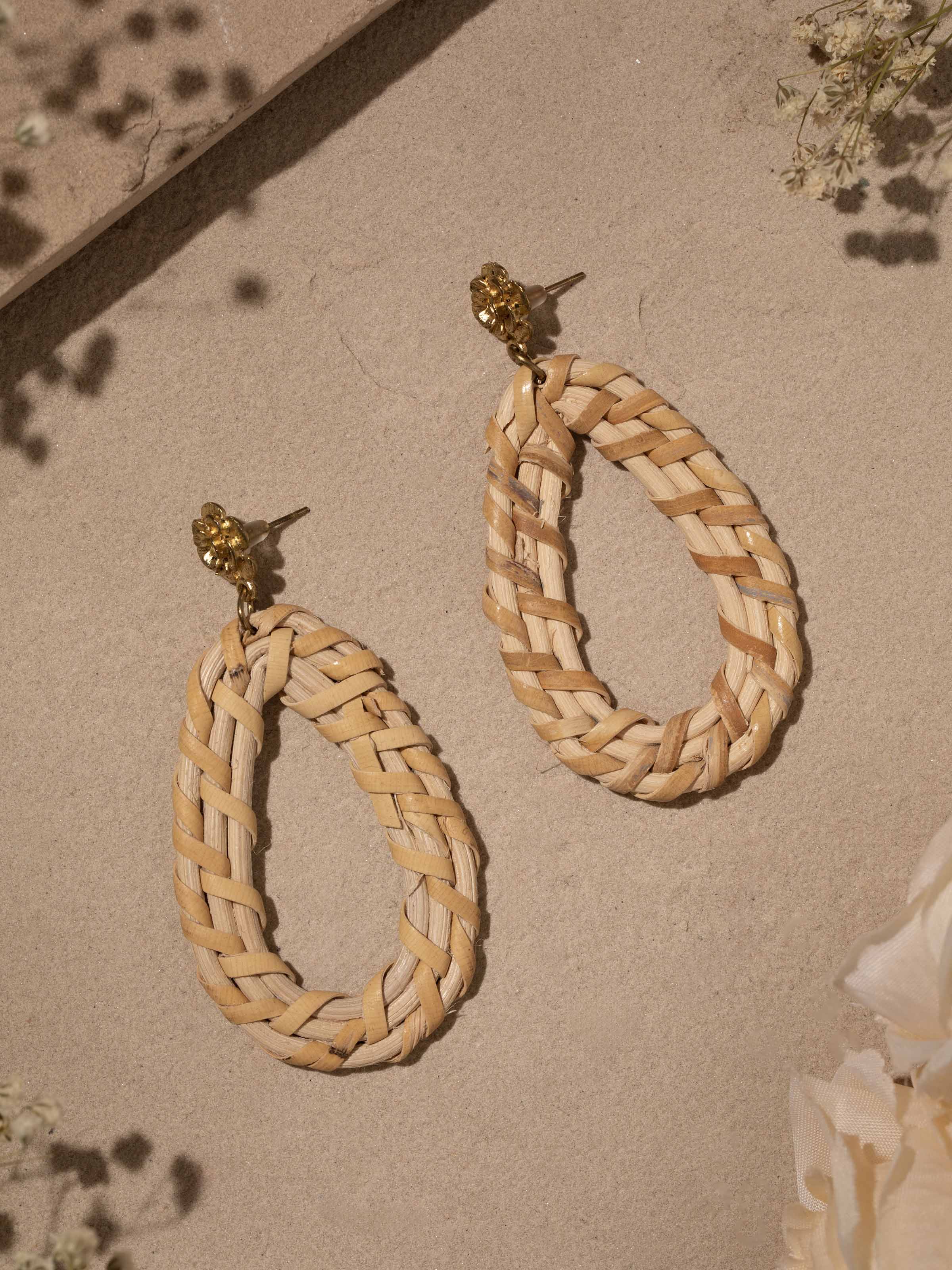 Close-up of handcrafted stud earrings highlighting detailed design and artistic elements