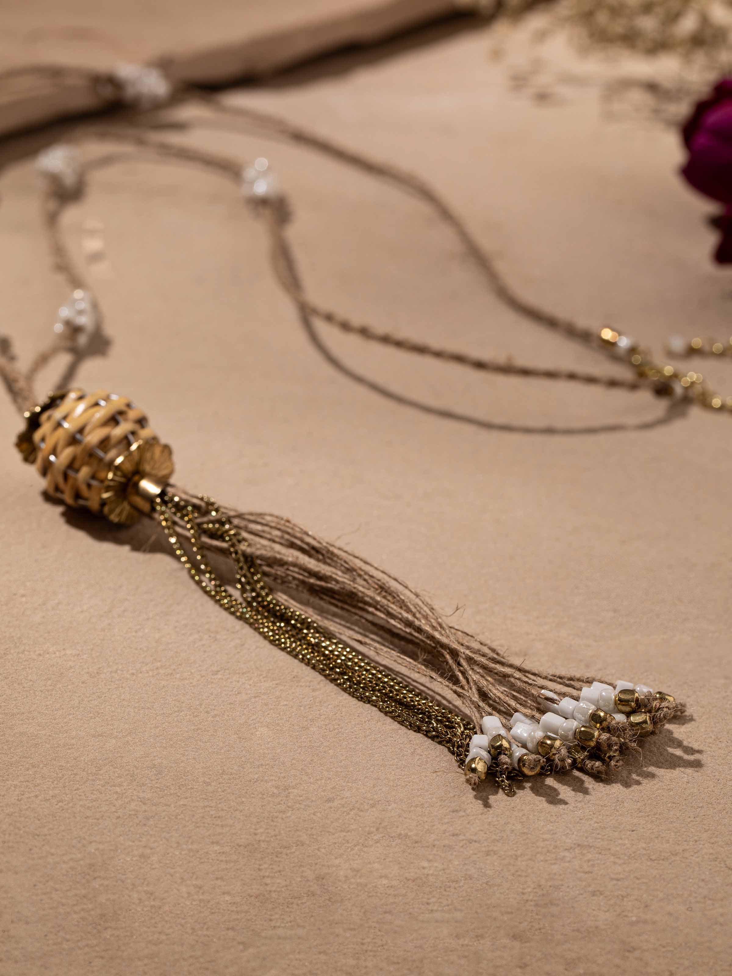 Detailed shot of handcrafted long necklace with a focus on its elaborate design