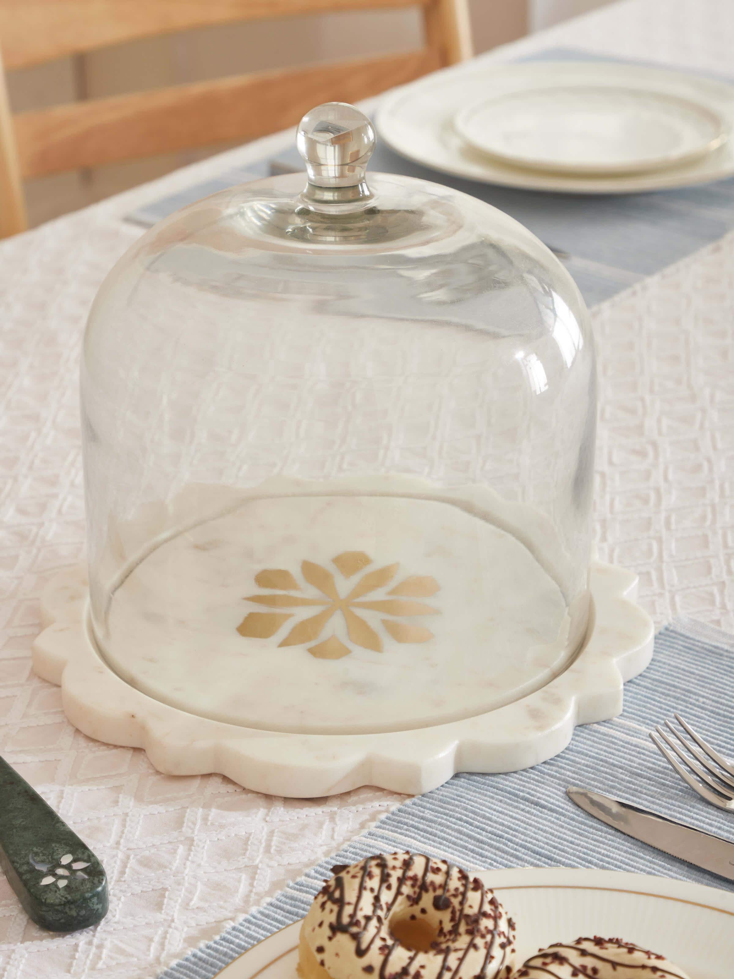 Close-up of carved marble and glass cloche highlighting the fine marble work