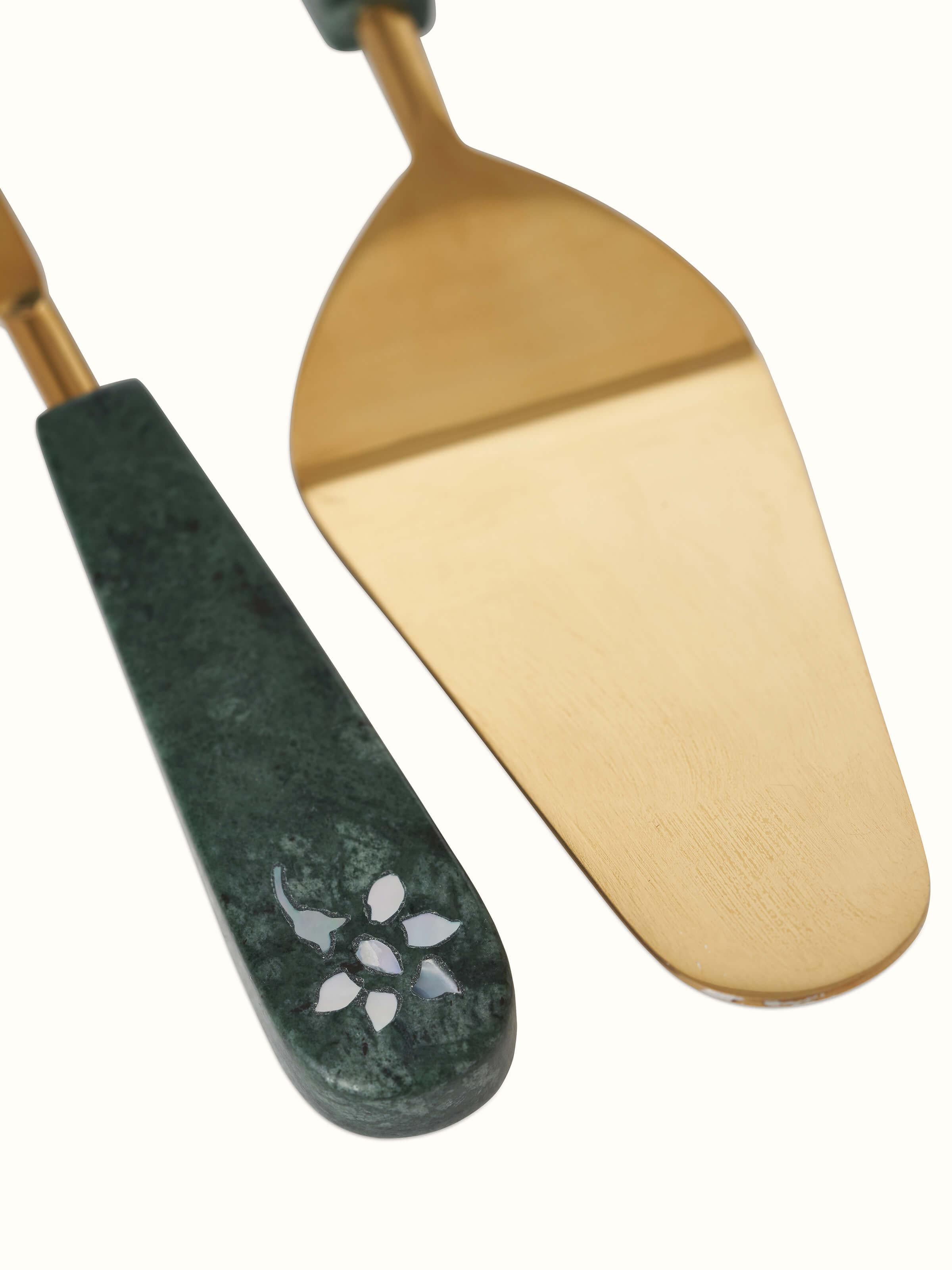 Close-up of marble & brass cake servers set of 2, emphasizing elegant marble inlays